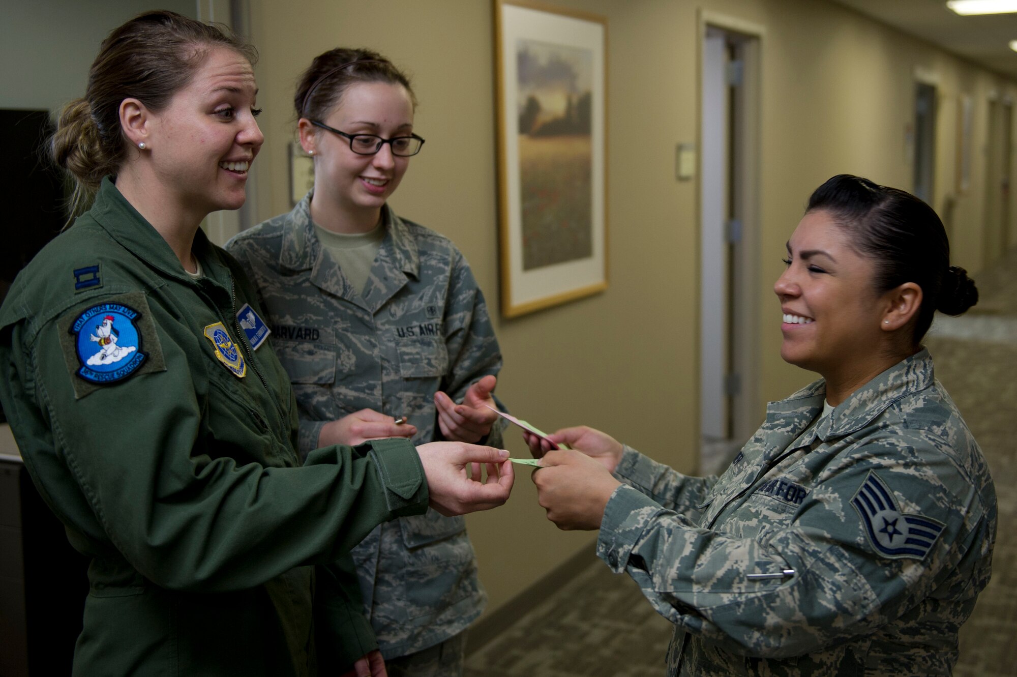 Staff Sgt. Marissa Reimer (right), 92nd Aerospace Medicine Squadron base operational medicine clinic medical technician, hands question cards to 92nd Medical Group Airmen March 15, 2016, at Fairchild Air Force Base, Wash. As part of Patient Safety Awareness week, 92nd MDG staff members participated in Jeopardy style question refresher training. Topics covered during training were: communication, locations of certain personnel, places and things, different medical codes, medication safety, medical acronyms and abbreviations, and TeamSTEPPS (Strategies and Tools to Enhance Performance and Patient Safety). (U.S. Air Force photo/Airman 1st Class Nick J. Daniello)