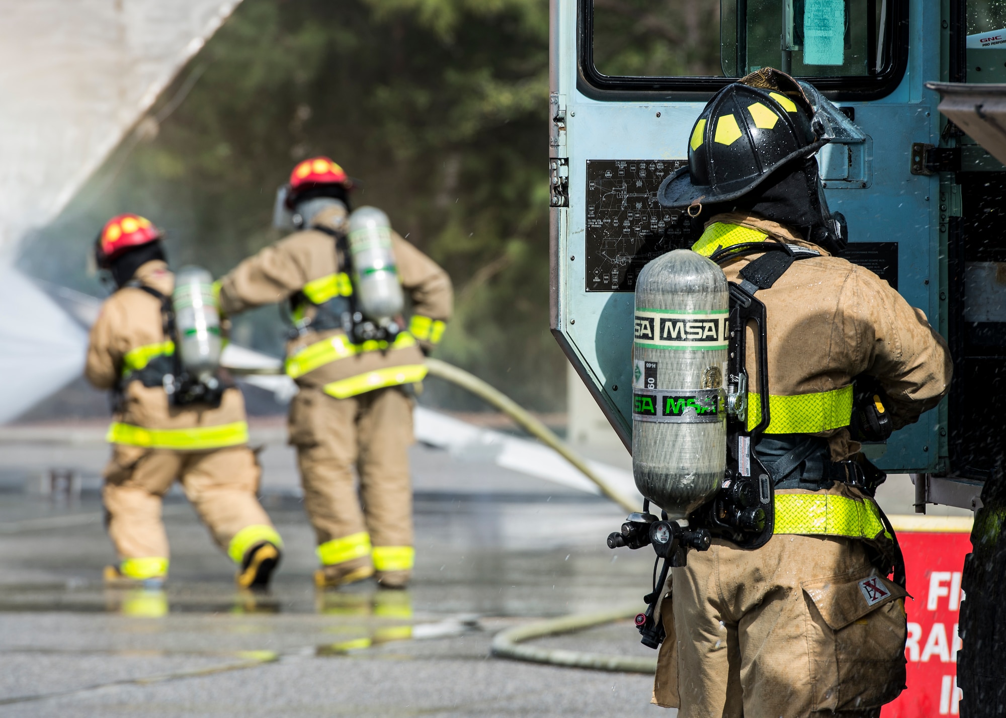 U.S. Air Force firefighters, assigned to the 633rd Civil Engineer Squadron, participate in an aircraft crash exercise in Hampton, Va., March 10, 2016. The exercise also provided Hampton Police and 633rd Security Forces Squadron training on properly containing a crash site ensuring unauthorized personnel did not get in the area. (U.S. Air Force photo by Airman 1st Class Derek Seifert) 