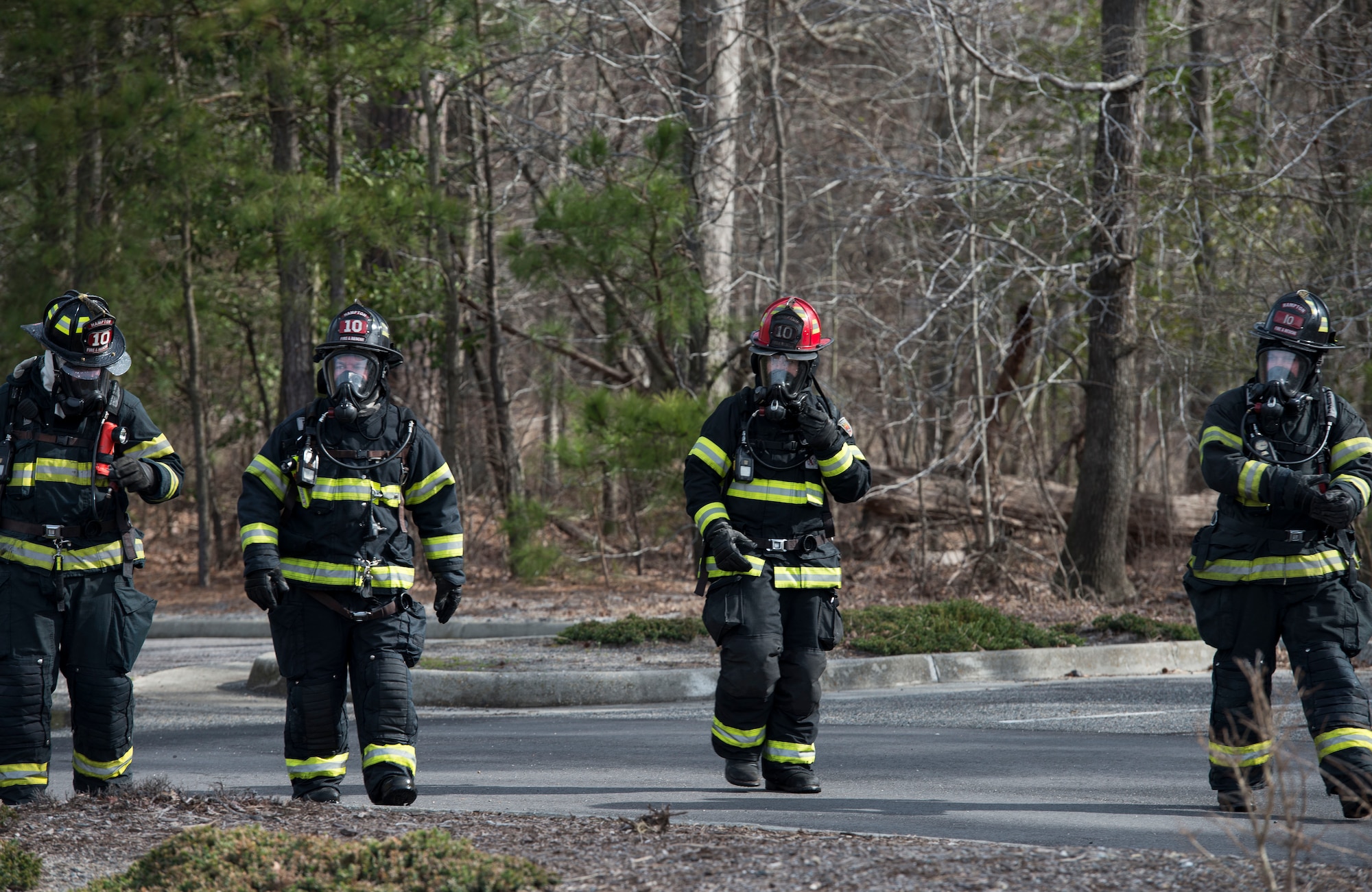 Hampton Division of Fire Rescue firefighters evaluate an aircraft crash exercise in Hampton, Va., March 10, 2016. The training scenario brought together the 633rd Air Base Wing, 1st and 192nd Fighter Wings, Sentara healthcare Center, and the Hampton Police and Fire Divisions to train for a real world situation, to look over plans, checklists and discrepancies. (U.S. Air Force photo by Airman 1st Class Derek Seifert)