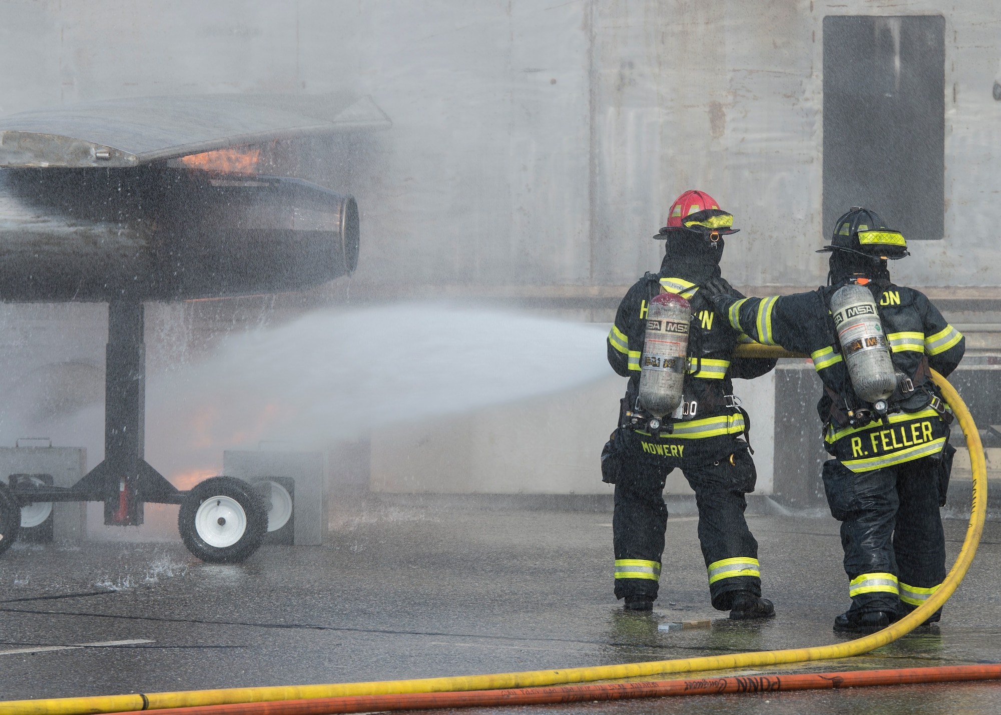 Hampton Division of Fire Rescue firefighters extinguish a simulated aircraft crash fire during an exercise in Hampton, Va., March 10, 2016. Langley Air Force Base firefighters and Security Forces assisted local first responders, Sentara Healthcare Center and Thomas Nelson Community College during the exercise to evaluate procedures and checklists to ensure they would be prepared if a real-world incident were to occur. (U.S. Air Force photo by Airman 1st Class Derek Seifert)