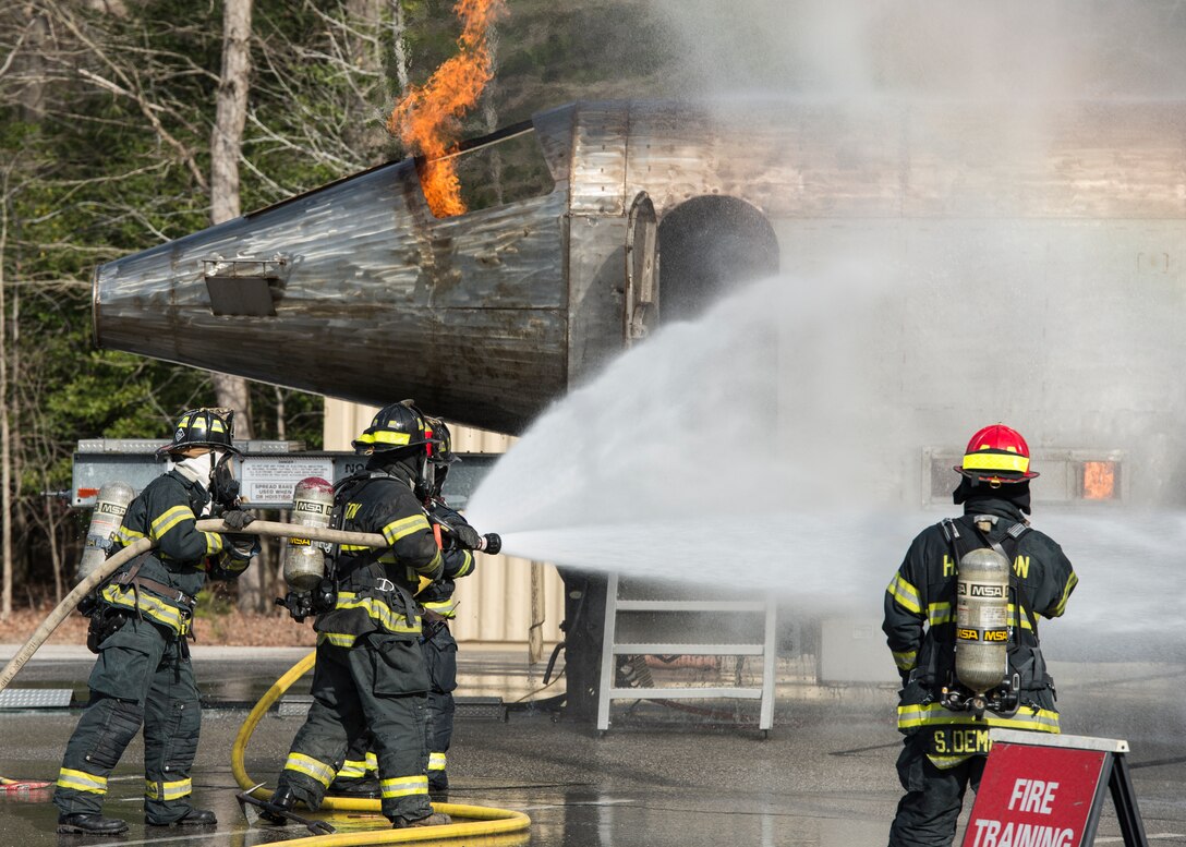 Hampton Division of Fire and Rescue firefighters extinguish a simulated F-22 Raptor fire during an exercise in Hampton, Va., March 10, 2016. The exercise lasted for two days and included a simulated search and rescue mission on Langley Air Force Base. (U.S. Air Force photo by Airman 1st Class Derek Seifert)