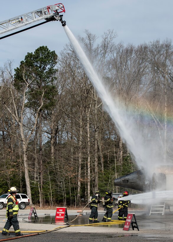Hampton Division of Fire and Rescue firefighters douse a simulated aircraft fire during an exercise in Hampton, Va., March 10, 2016. The exercise allowed Hampton firefighters and police, Sentara Healthcare Center, Thomas Nelson Community College and personnel from Langley Air Force Base the opportunity to train for a real-world incident. (U.S. Air Force photo by Airman 1st Class Derek Seifert)