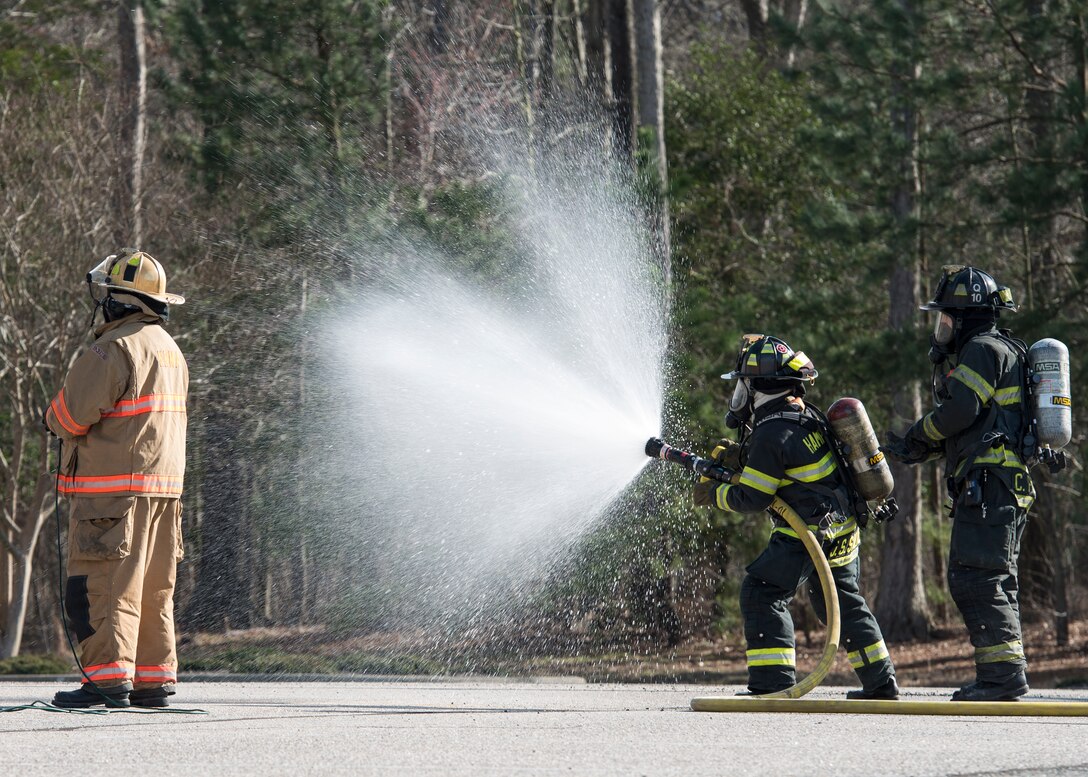 Hampton Division of Fire and Rescue firefighters extinguish a simulated aircraft fire during an exercise in Hampton, Va., March 10, 2016. The exercise evaluated Joint Base Langley-Eustis and local first responders on procedures for an aircraft crash off-base. (U.S. Air Force photo by Airman 1st Class Derek Seifert)