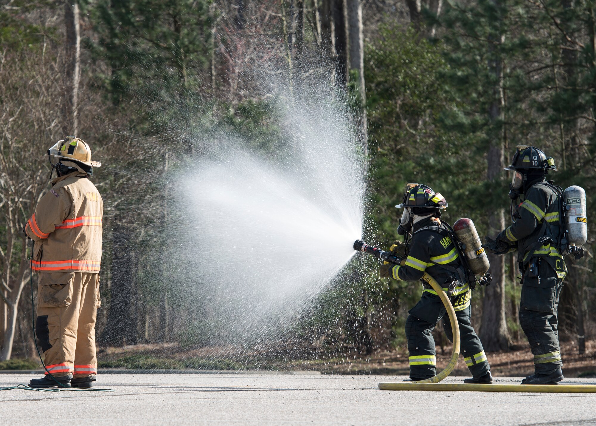 Hampton Division of Fire and Rescue firefighters extinguish a simulated aircraft fire during an exercise in Hampton, Va., March 10, 2016. The exercise evaluated Joint Base Langley-Eustis and local first responders on procedures for an aircraft crash off-base. (U.S. Air Force photo by Airman 1st Class Derek Seifert)