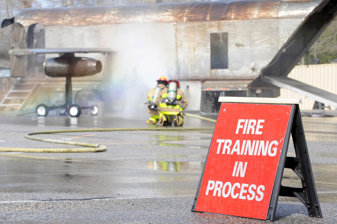 Firefighters assigned to the 633rd Civil Engineer Squadron extinguish a fire during a joint exercise in Hampton, Va., March 10, 2016. The exercise was designed to be as realistic as possible to better prepare local organizations for possible real-world scenarios. (U.S. Air Force photo by Senior Airman Brittany E. N. Murphy))