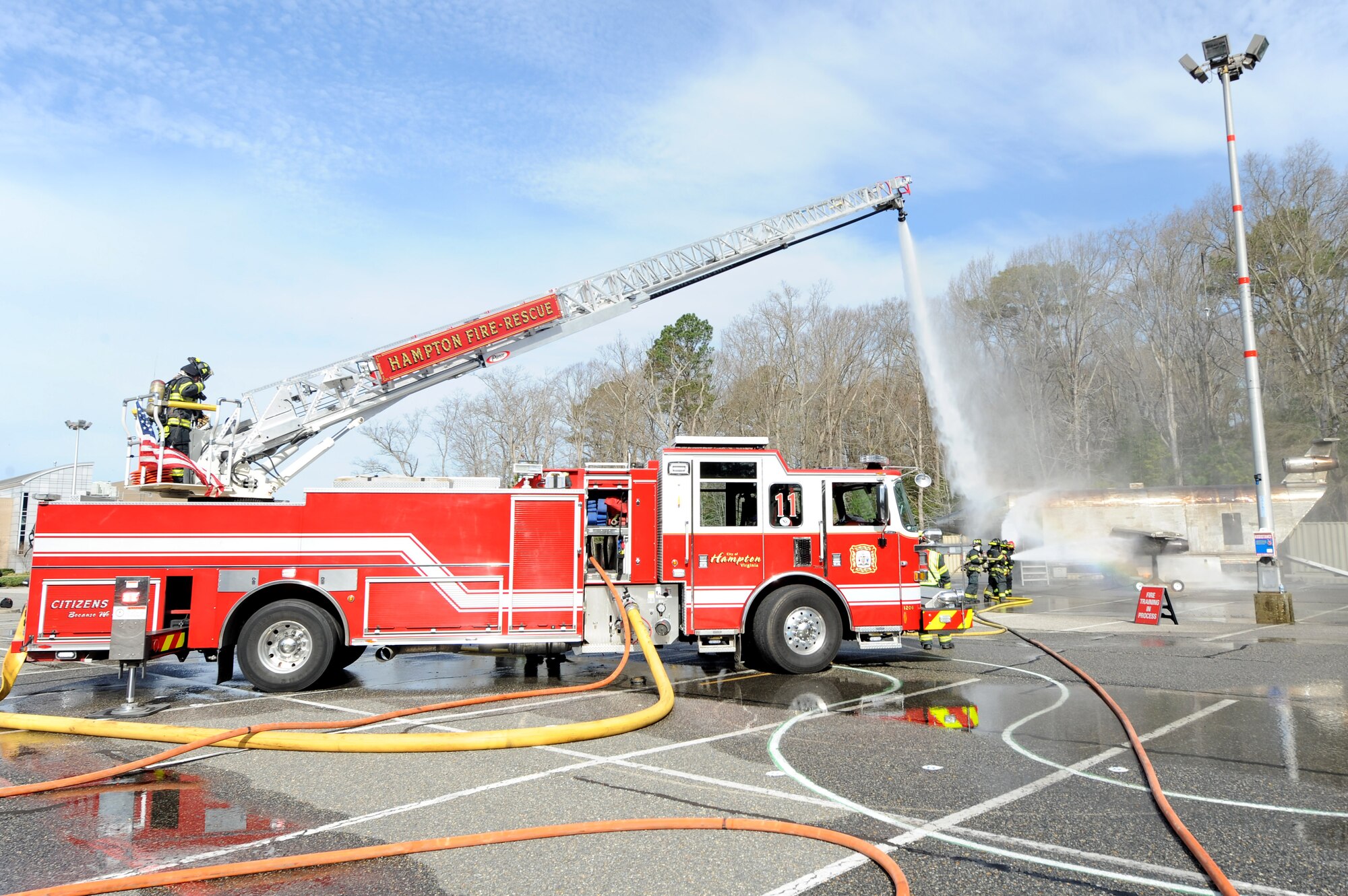 Hampton Division of Fire and Rescue firefighters put out a controlled fire during a joint exercise in Hampton, Va., March 10, 2016. The exercise was held at Thomas Nelson Community College and simulated an F-22 Raptor crash. (U.S. Air Force photo by Senior Airman Brittany E. N. Murphy)