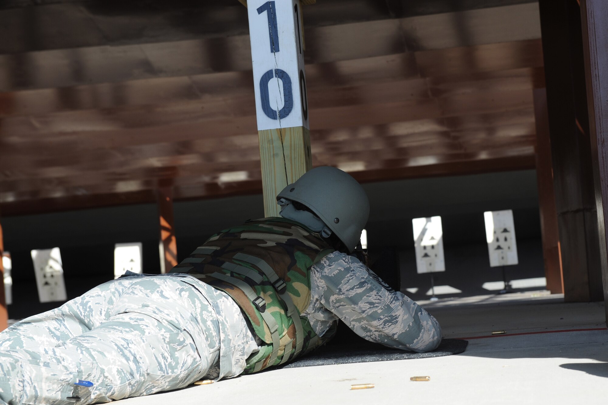 U.S. Air Force Master Sgt. Tiffany Buford, a safety occupational manager assigned to the 633rd Air Base Wing, prepares to fire an M-4 Carbine at Langley Air Force Base, Va., March 8, 2016. Buford must qualify on the M-4 in order to be eligible for an upcoming deployment. (U.S. Air Force photo by Senior Airman Brittany E. N. Murphy)