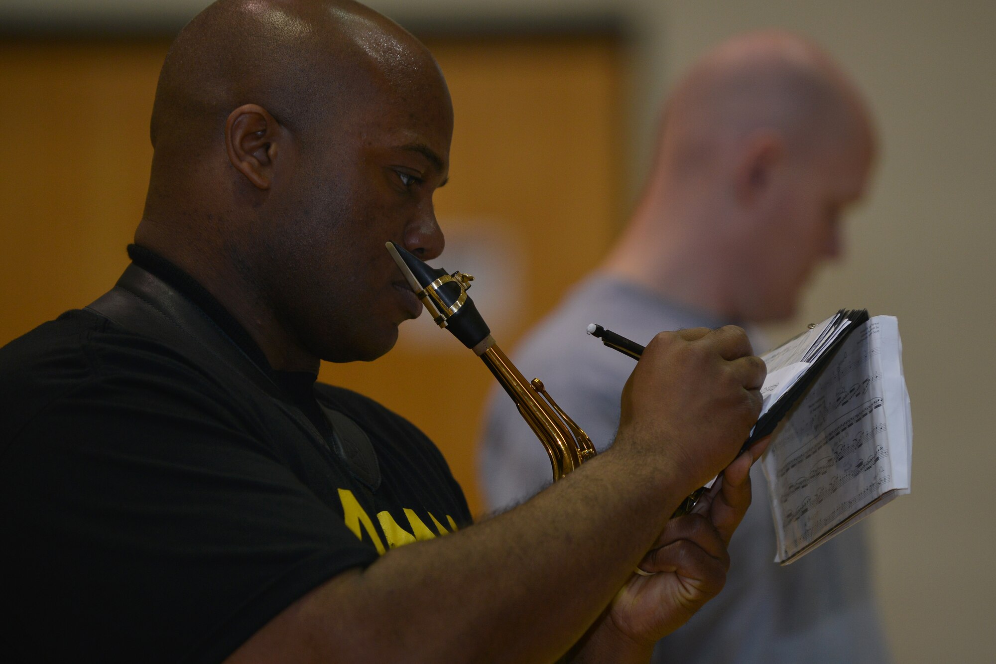 U.S. Army Staff Sgt. Kollister Williams II, a senior instrumentalist with the U.S. Army Training and Doctrine Command band, takes notes during practice at Fort Eustis, Va., March 10, 2016. The ensemble can trace its roots to the Band, 2nd Coast Artillery, which was originally organized April 30, 1931. (U.S. Air Force photo by Staff Sgt. Natasha Stannard)