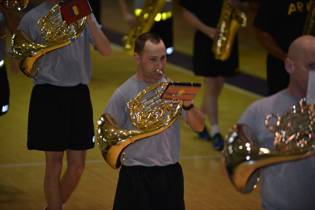 U.S. Army Spc. Lesley Harkey, instrumentalist with the U.S. Army Training and Doctrine Command band, plays the French Horn during practice at Fort Eustis, Va., March 10, 2016. The approximately 54-member ensemble will perform a marching show representing the Army over the last 20 years at the Virginia International Tattoo. (U.S. Air Force photo by Staff Sgt. Natasha Stannard)
