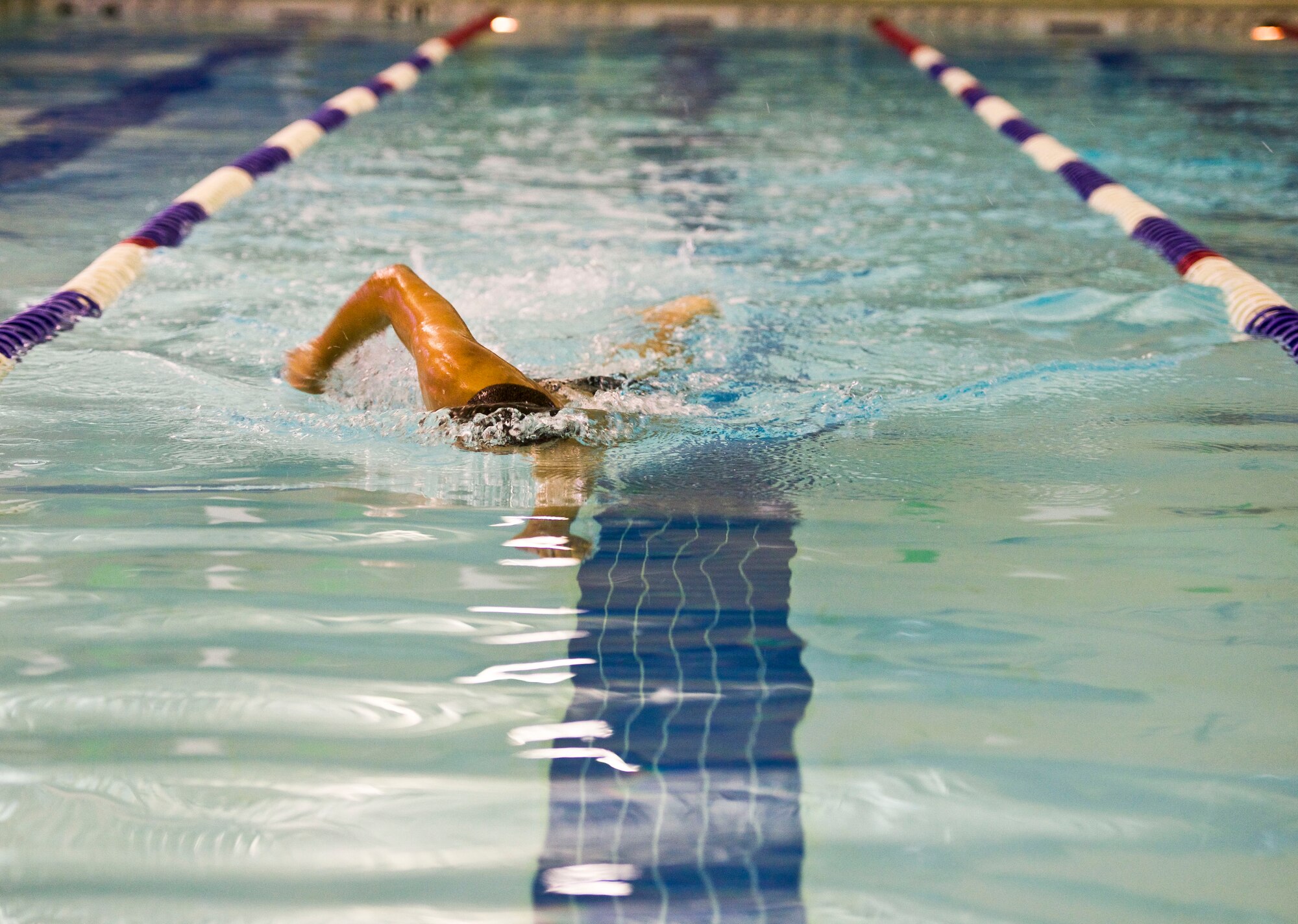 U.S. Air Force Senior Airman D’Vonte Washburn, an aircraft maintenance scheduler with the 1st Maintenance Group, swims during the Physical Aptitude Stamina Test (PAST) at Langley Air Force Base, Va., March 3, 2016. The P.A.S.T. evaluates candidates on physical and mental preparedness for additional challenges throughout the career training. The PAST evaluates candidates on their physical and mental preparedness using two 25-meter subsurface swims, a 500-meter surface swim, one-mile and a half run, push-ups, pull-ups and sit-ups. (U.S. Air Force photo by Airman 1st Class Derek Seifert)