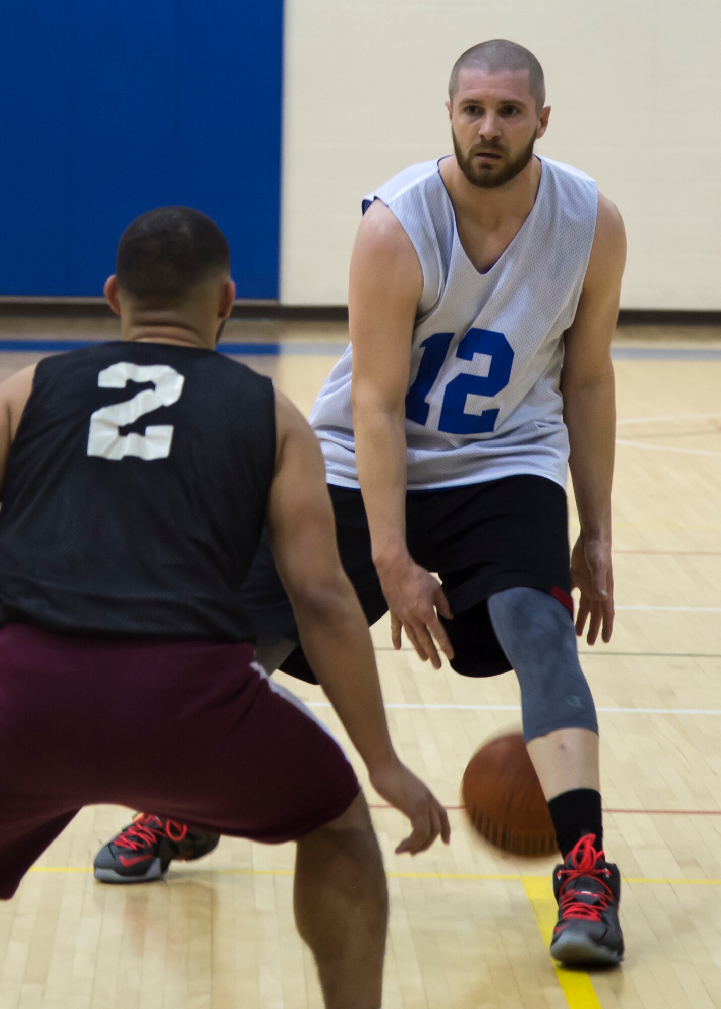 James Barnes, center for the Langley All-Stars, dribbles the ball in isolation while defended by DJ Maddux, shooting guard for the Fort Eustis All-Stars, during the Joint Base Langley-Eustis all-star basketball game at Langley Air Force Base, Va., March 9, 2016. Barnes played on the 633rd Force Support Squadron championship team this season. (U.S. Air Force photo by Staff Sgt. J.D. Strong II)