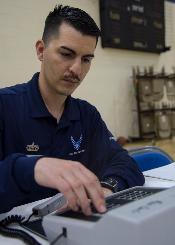 U.S. Air Force Staff Sgt. Roy Silva, a sports director assigned to the 633rd Force Support Squadron, keeps score during the Joint Base Langley-Eustis all-star basketball game at Langley Air Force Base, Va., March 9, 2016. The intramural basketball season was 12 games long, with the 633rd FSS squadron having a record for 12 wins and zero losses. (U.S. Air Force photo by Staff Sgt. J.D. Strong II)