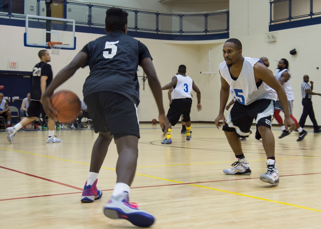 Tony Friend, point guard for the Eustis All-Stars, performs a cross-over on Langley All-Stars guard, Emanuel Stuppard, during the Joint Base Langley-Eustis all-star basketball game at Langley Air Force Base, Va., March 9, 2016. Friend used his speed to start fast-breaks and penetrate the Langley All-Stars’ defense leading to his team’s 64-53 win. (U.S. Air Force photo by Staff Sgt. J.D. Strong II) 