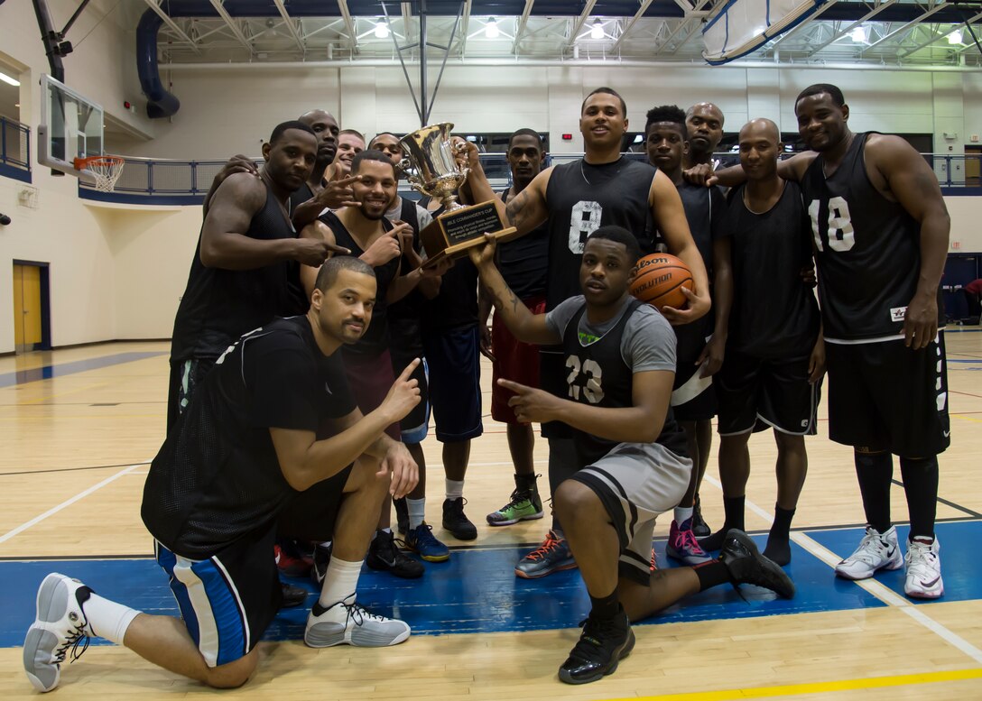 The Fort Eustis All-Stars pose with the Joint Base Langley-Eustis all-star basketball game trophy at Langley Air Force Base, Va., March 9, 2016.The Eustis All-Stars used intense man and help defense to defeat the Langley All-Stars. (U.S. Air Force photo by Staff Sgt. J.D. Strong II)
