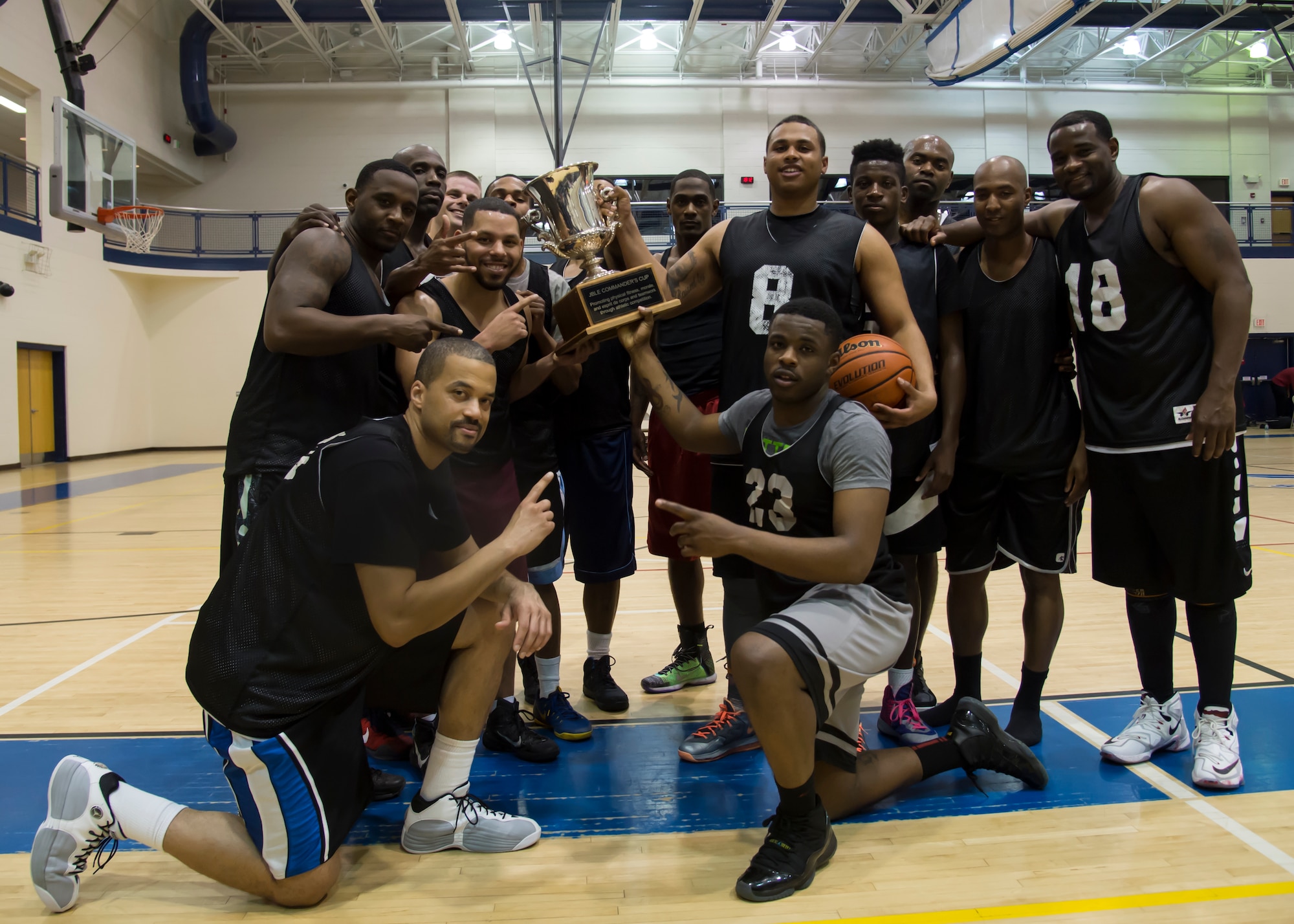 The Fort Eustis All-Stars pose with the Joint Base Langley-Eustis all-star basketball game trophy at Langley Air Force Base, Va., March 9, 2016.The Eustis All-Stars used intense man and help defense to defeat the Langley All-Stars. (U.S. Air Force photo by Staff Sgt. J.D. Strong II)
