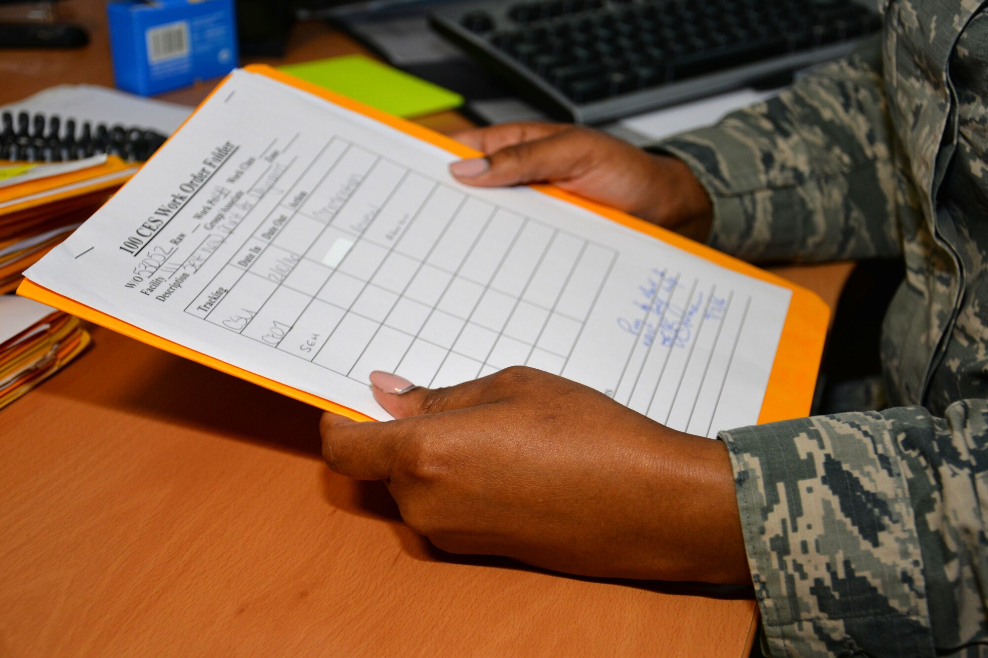 U.S. Air Force Staff Sgt. Diamond Wilkins, 100th Civil Engineer Squadron requirements and optimization section craftsman, checks a work order March 9, 2016, on RAF Mildenhall, England. Wilkins and her team prioritize work requests to ensure those that directly relate to the mission have a higher priority. (U.S. Air Force photo by Gina Randall/Released)