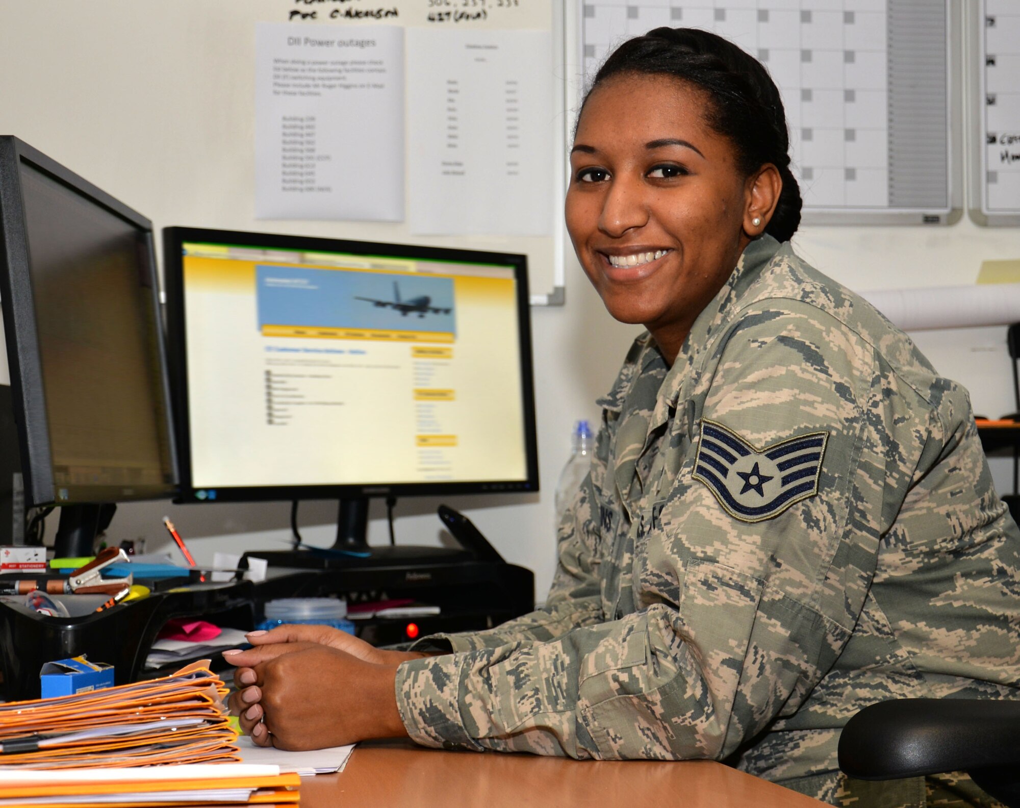 U.S. Air Force Staff Sgt. Diamond Wilkins, 100th Civil Engineer Squadron requirements and optimization section craftsman, poses for a photograph at her desk March 9, 2016, on RAF Mildenhall, England. Wilkins joined the military after advice from family. (U.S. Air Force photo by Gina Randall/Released)