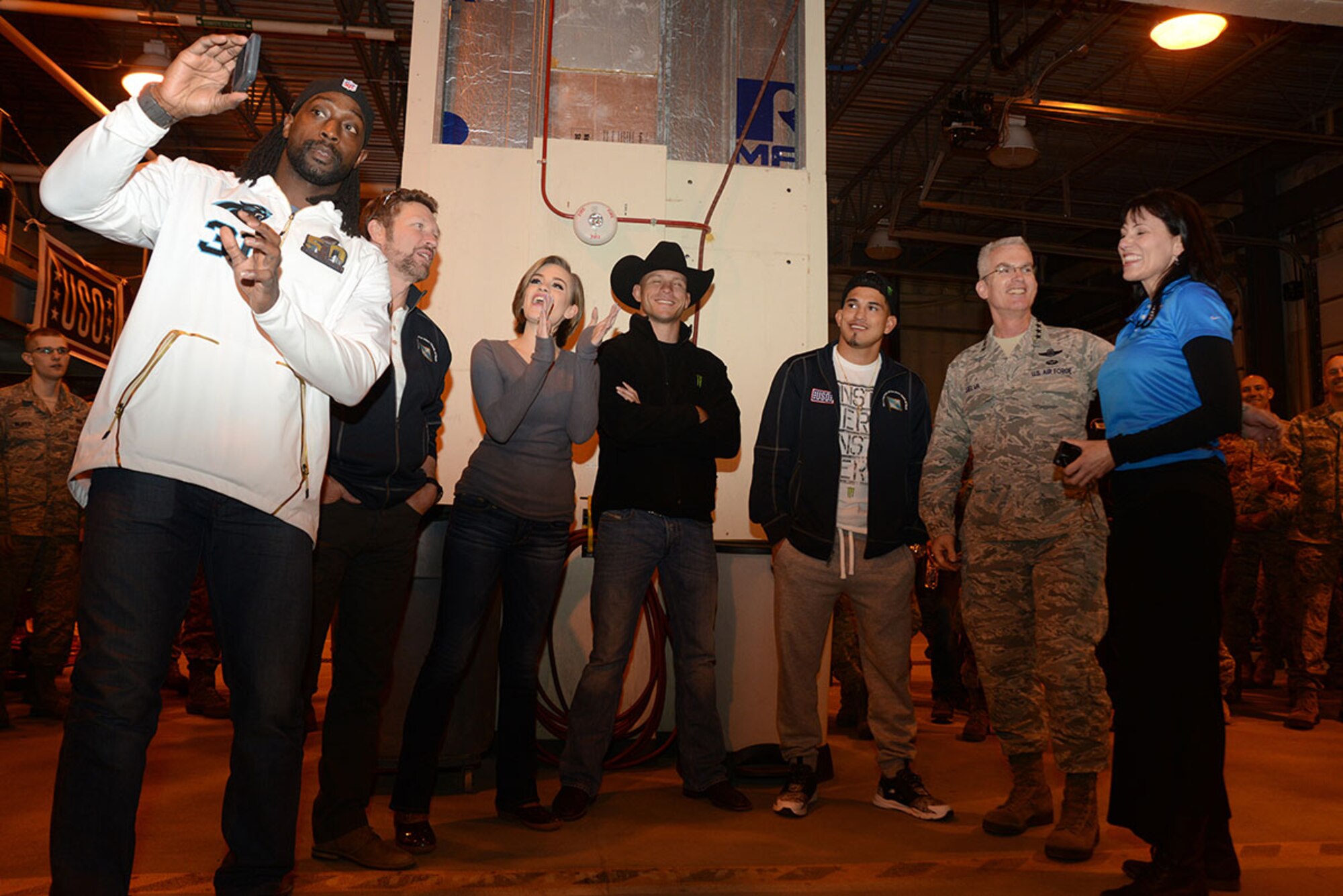 The USO Spring 2016 Entertainment Tour featuring Miss America Betty Cantrell, country singer and 10-year Army veteran Craig Morgan, Carolina Panthers football player Charles Tillman, Ultimate Fighting Championship fighters Anthony Pettis and Donald ‘Cowboy’ Cerrone, led by Air Force Gen. Paul Selva, 10th Vice Chairman of the Joint Chiefs of Staff, line up a photograph with Tara Mogan, Alaska state USO director, at Joint Base Elmendorf-Richardson, Alaska, March 12, 2016. General Selva used this opportunity to get close to the Arctic Warriors at the JBER USO, Buckner Fitness Center and Fire Station 4. (U.S. Air Force photo by Airman 1st Class Christopher R. Morales)