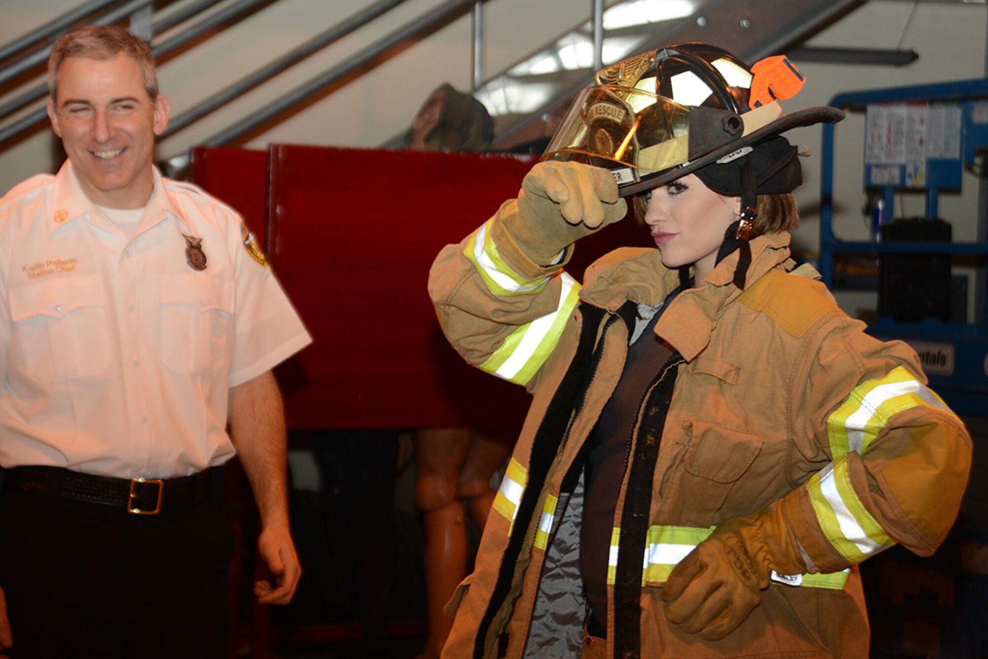 Miss America Betty Cantrell tries on firefighting equipment during the USO Fire Station luncheon as part of the USO Spring 2016 Entertainment Tour starting at Joint Base Elmendorf-Richardson, Alaska, March 12, 2016. Air Force Gen. Paul Selva, 10th Vice Chairman of the Joint Chiefs of Staff, led the tour also featuring country singer and 10-year Army veteran Craig Morgan, Carolina Panthers football player Charles Tillman, and Ultimate Fighting Championship fighters Anthony Pettis and Donald ‘Cowboy’ Cerrone. (U.S. Air Force photo by Airman 1st Class Christopher R. Morales)
