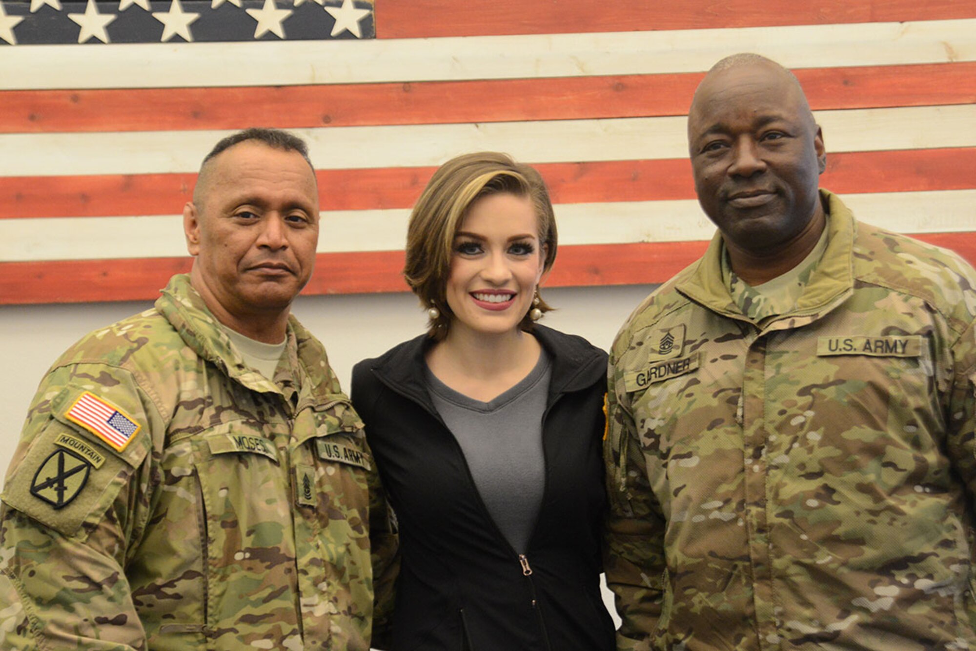 Command Sgt. Maj. Eugene Moses, Joint Base Elmendorf-Richardson Command Sgt. Maj., Command Sgt. Maj. Terry Gardner, USARAK Command Sgt. Maj., and Miss America Betty Cantrell pose for a picture at the JBER USO during the USO Spring 2016 Entertainment Tour March 12, 2016. Air Force Gen. Paul Selva, 10th Vice Chairman of the Joint Chiefs of Staff, led the tour also featuring country singer and 10-year Army veteran Craig Morgan, Carolina Panthers football player Charles Tillman, and Ultimate Fighting Championship fighters Anthony Pettis and Donald ‘Cowboy’ Cerrone. (U.S. Air Force photo by Airman 1st Class Christopher R. Morales)