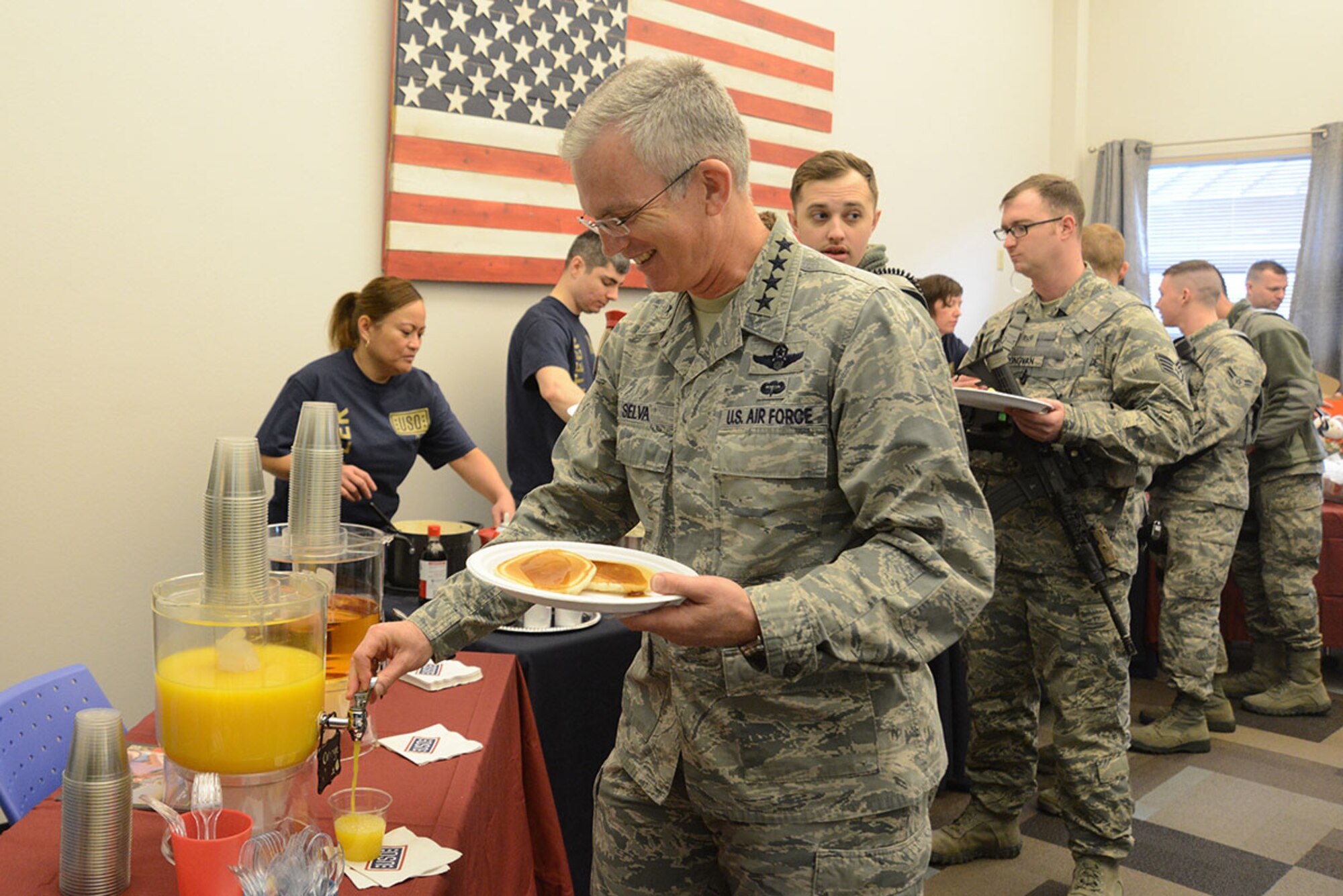 Air Force Gen. Paul Selva, 10th Vice Chairman of the Joint Chiefs of Staff, pours a cup of orange juice for himself at the Joint Base Elmendorf-Richardson, Alaska, USO pancake breakfast, the first stop for the USO Spring 2016 Entertainment Tour March 12, 2016. The tour also features Miss America Betty Cantrell, country singer and 10-year Army veteran Craig Morgan, Carolina Panthers football player Charles Tillman, and Ultimate Fighting Championship fighters Anthony Pettis and Donald ‘Cowboy’ Cerrone. (U.S. Air Force photo by Airman 1st Class Christopher R. Morales)