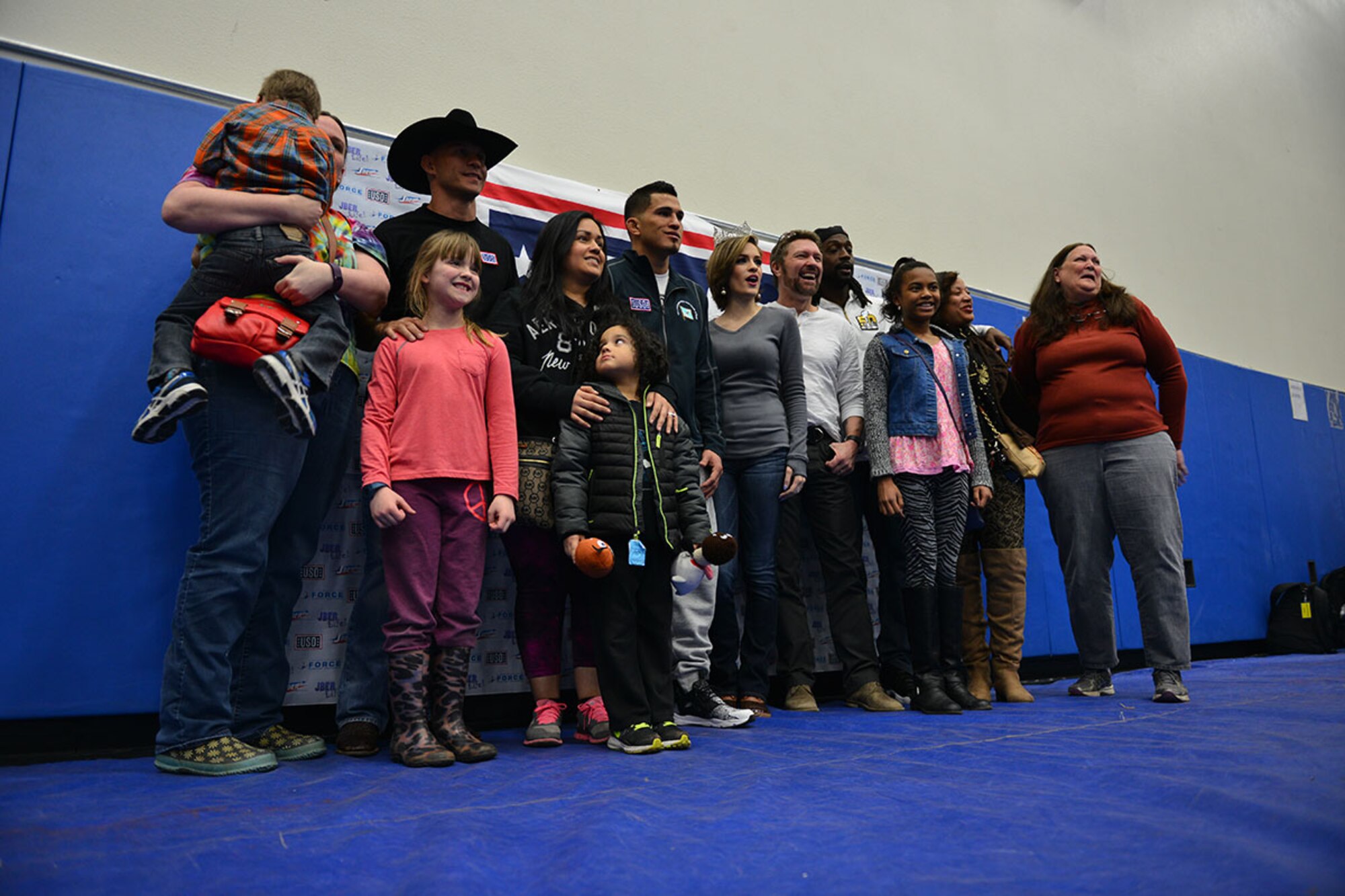Celebrities take pictures with the crowd at the USO Spring 2016 Entertainment Tour featuring Miss America Betty Cantrell, country singer and 10-year Army veteran Craig Morgan, Panthers football player Charles Tillman, and Ultimate Fighting Championship fighters Anthony Pettis and Donald ‘Cowboy’ Cerrone at Joint Base Elmendorf-Richardson March 12. The tour was led by Air Force Gen. Paul Selva, 10th Vice Chairman of the Joint Chiefs of Staffs, who used this as an opportunity to visit Arctic Warriors. (U.S. Air Force photo by Airman 1st Class Kyle Johnson)