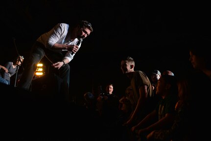 Country singer and 10-year Army veteran Craig Morgan, leans down to listen to a boy ask him a question at the USO Spring 2016 Entertainment Tour March 12, in the Buckner Physical Fitness Center at Joint Base Elmendorf-Richardson. The tour also featured Miss America Betty Cantrell, North Carolina Panthers football player Charles Tillman, and Ultimate Fighting Championship fighters Anthony Pettis and Donald ‘Cowboy’ Cerrone visited JBER for their first stop. (U.S. Air Force photo by Airman 1st Class Kyle Johnson)