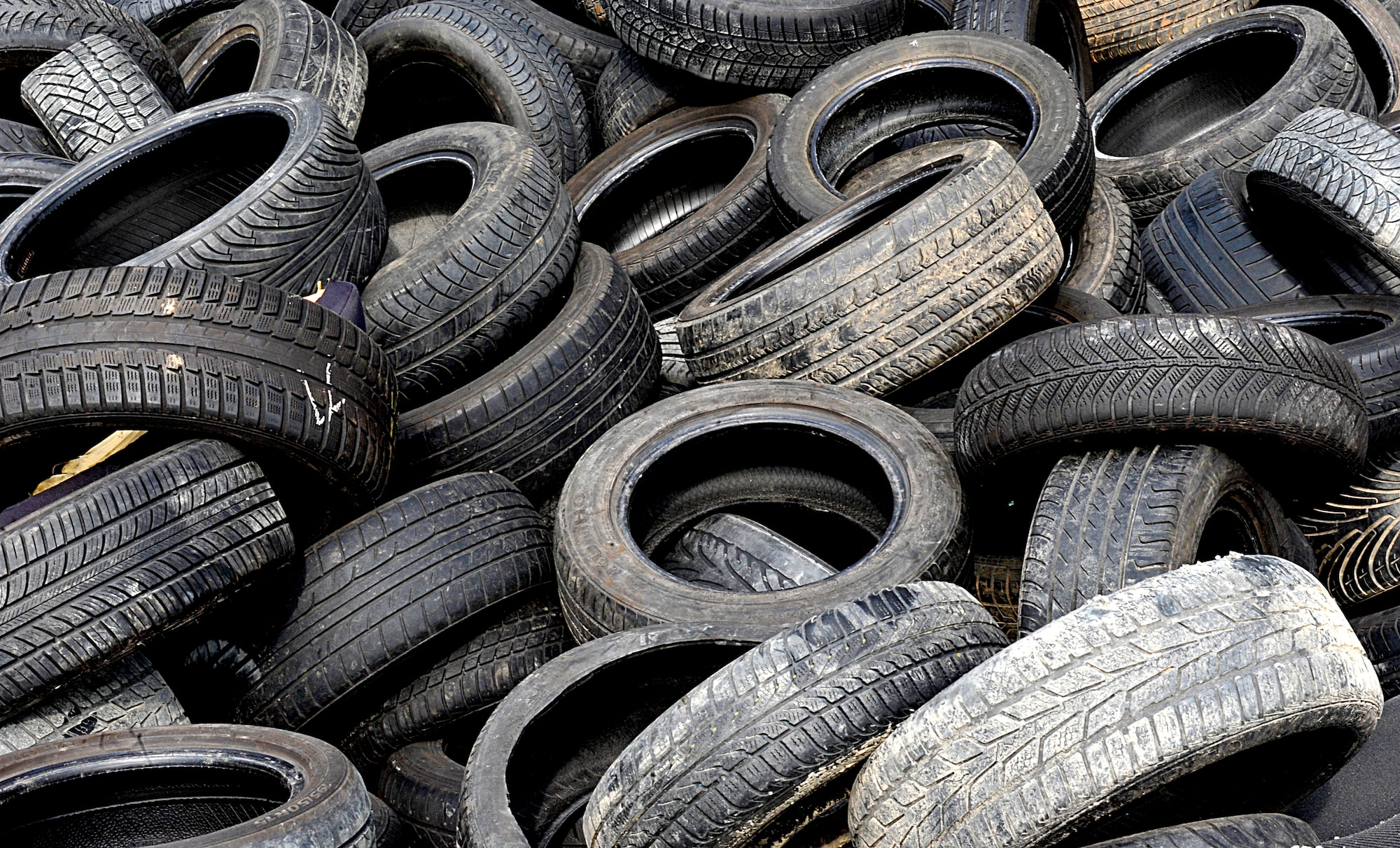 Tires lay in a pile at the Ramstein Automotive Recycling Center March 1, 2016, at Ramstein Air Base, Germany. The center receives 70 to 80 cars a month and consistently sells car parts for prices comparable to those at a local establishment. (U.S. Air Force photo/Airman 1st Class Larissa Greatwood)