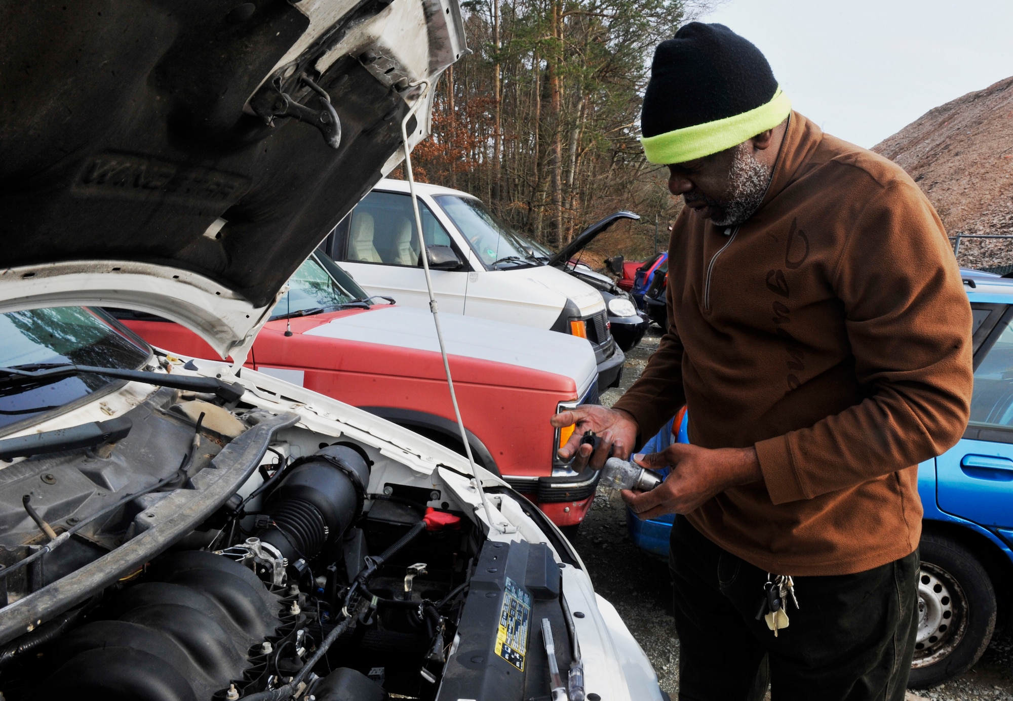 Herbert Doyle, Landstuhl Regional Medical Center lodging laborer, removes a car part at the Ramstein Automotive Recycling Center March 1, 2016, at Ramstein Air Base, Germany. The recycling center accepts unservicable cars to sell as parts as well as cars sold to the highest bidder. (U.S. Air Force photo/Airman 1st Class Larissa Greatwood) 