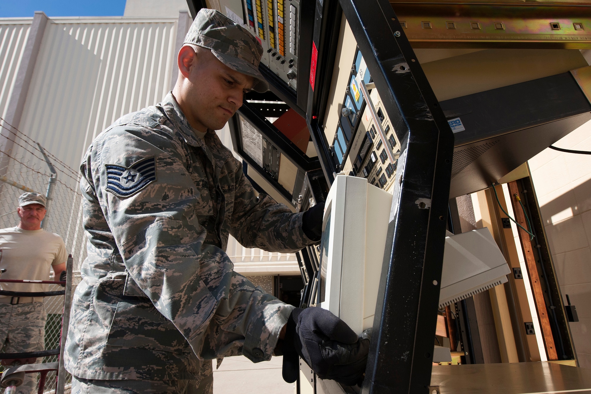 Tech. Sgt. Anthony Garcia, 272nd Engineering Installation Squadron, Communication Team Installer, disassembles a legacy console unit from the Launch and Test Range System prior to its relocation to Vandenberg's Space and Missile Heritage Center March 2, 2016, Vandenberg Air Force Base, Calif. Garcia is part of an Air National Guard EI team working on a relocation of the Launch and Test Range System for the Western Range. (U.S. Air Force photo by Michael Peterson/released)