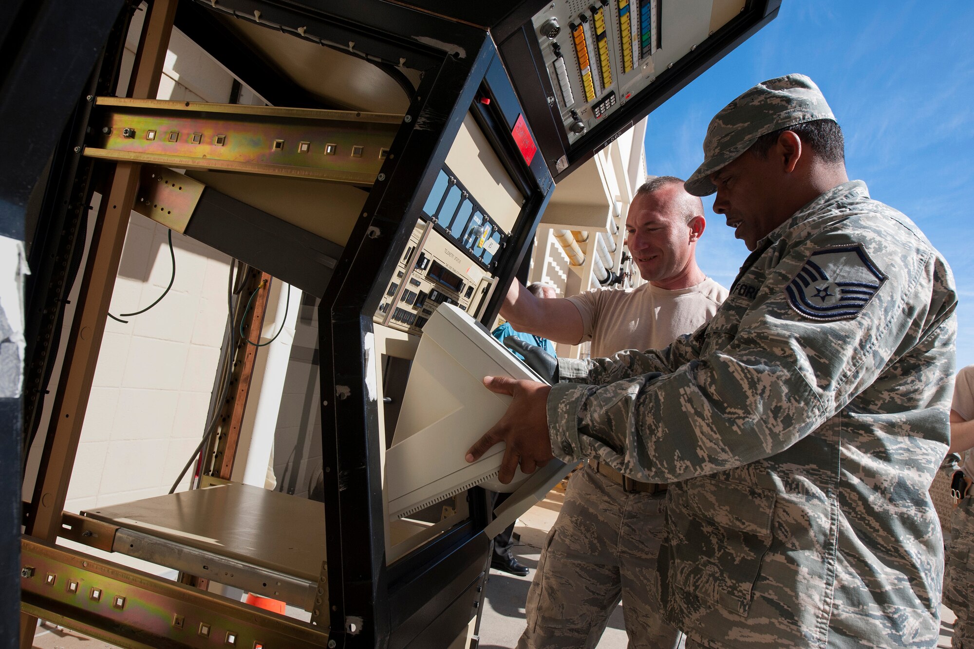 Master Sgt. Maurice McKenniss, 270th Engineering Installation Squadron, Range Simulation Center Installer, and TSgt Mark Yurkiewicz, 270th EIS, Telemetry Analog Equipment Room Installer, disassemble a legacy console unit from the Launch and Test Range System prior to its relocation to Vandenberg's Space and Missile Heritage Center March 2, 2016, Vandenberg Air Force Base, Calif. McKenniss and Yurkiewicz are part of an Air National Guard EI team working on a relocation of the Launch and Test Range System for the Western Range. (U.S. Air Force photo by Michael Peterson/released)