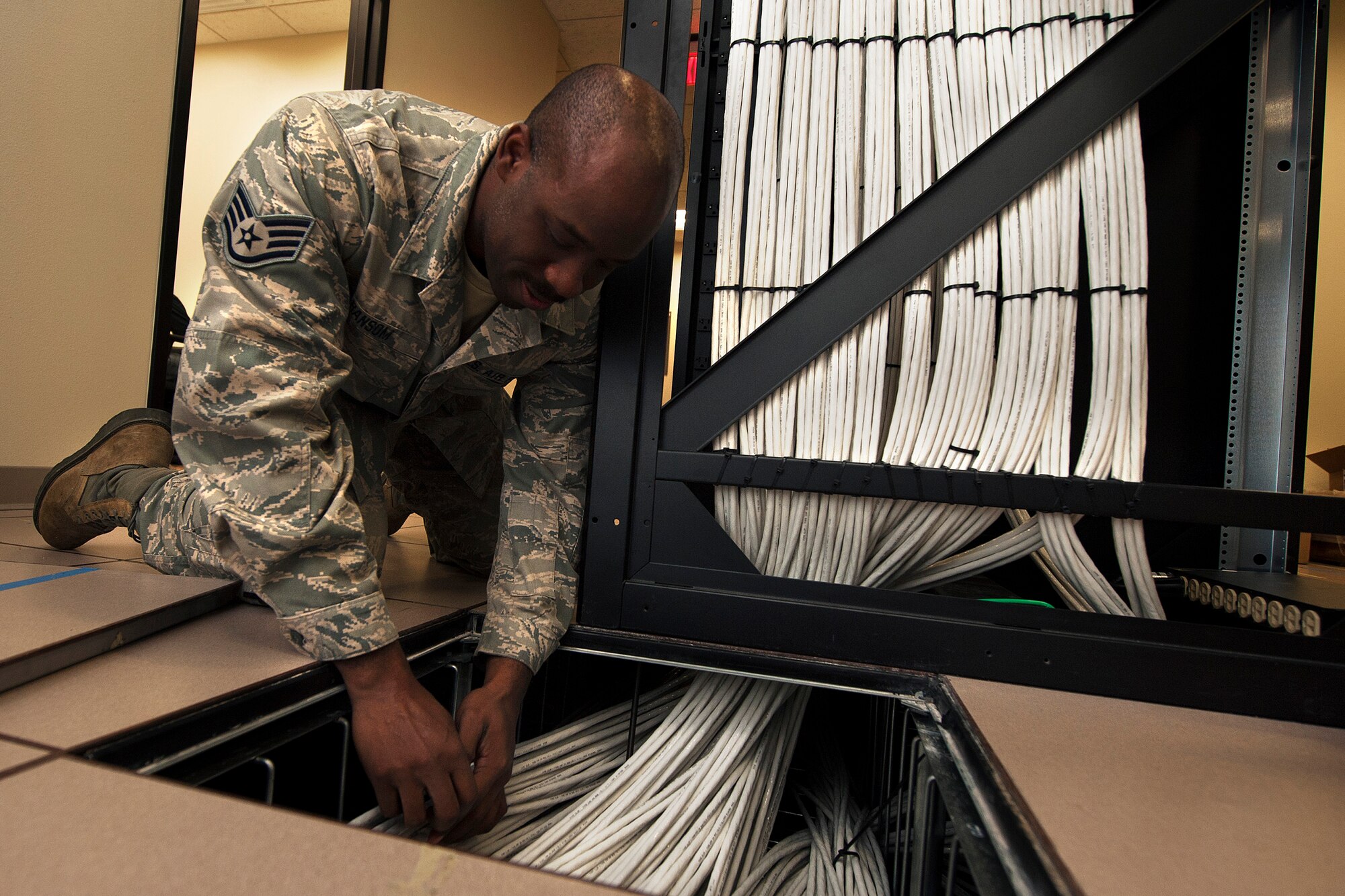 Staff Sgt. Christopher Ransom, 270th Engineering Installation Squadron, Communication Team Installer, inspects a bundle of recently built and installed cables March 2, 2016, Vandenberg Air Force Base, Calif. Ransom is part of an Air National Guard EI team working on a relocation of the Launch and Test Range System for the Western Range. (U.S. Air Force photo by Michael Peterson/released)