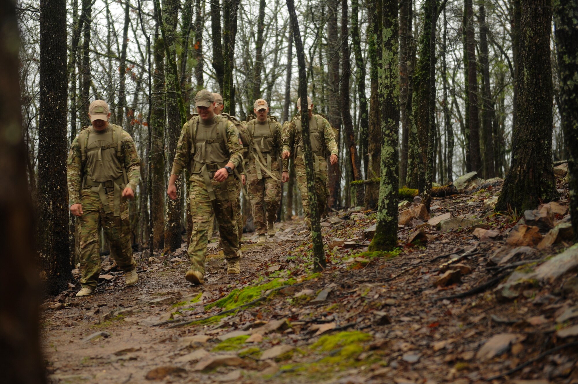 U.S. Airmen from the 19th Logistics Readiness Squadron traverse through terrain March 11, 2016, at Burns Park in North Little Rock, Ark. The team is training for the Bataan Memorial Death March, at White Sands Missile Range, N.M.; which consists of 26.2 miles of desert terrain including two miles through sand. (U.S. Air Force photo/Senior Airman Harry Brexel)
