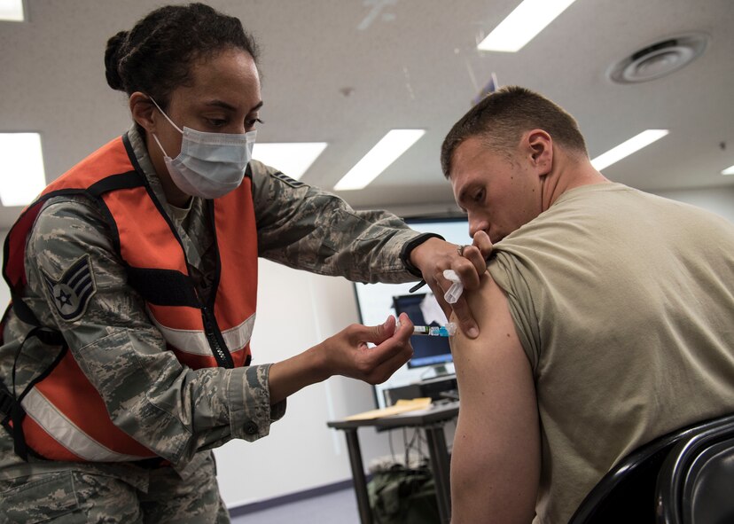 U.S. Air Force Staff Sgt. Cherie Gregory, the allergy immunizations NCO-in-charge with the 35th Medical Operations Squadron, administers a vaccine at Misawa Air Base, Japan, March 15, 2016. While taking part in Beverly Sunrise 16-03, an operational readiness exercise, Airmen attended a mock personnel deployment function ensuring their medical records were up-to-date. Personnel who were due for vaccinations received them before the mock departure. (U.S. Air Force photo by Airman 1st Class Jordyn Fetter) 