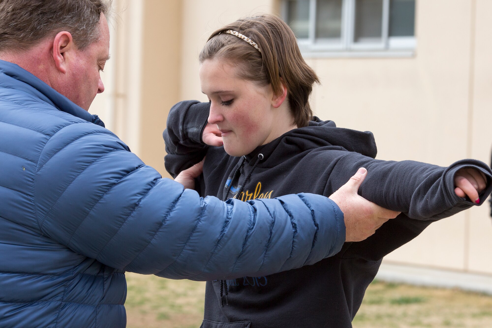 Ken Flax, former Olympic participant, teaches throwing techniques to Maddie Green, Yokota High School student, during the World Records Camp at Yokota Air Base, Japan, March 12, 2016. Four track and field gold medalists visited Yokota to coach track and field events. Over 70 students participated in two-day camp. (U.S. Air Force photo by Osakabe Yasuo/Released) 