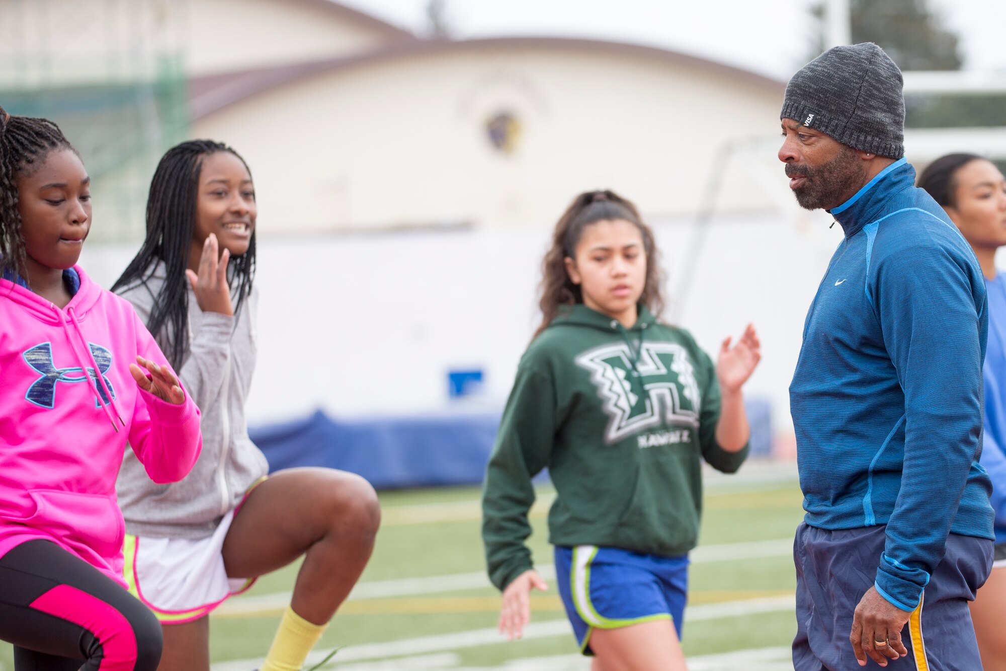 Gregg Simmons, world records camp sprints coach, teaches running form to participants from the Yokota High School during a two-day track and field camp hosted by World Records Camp at Yokota Air Base, Japan, March 12, 2016. Four track and field gold medalists visited Yokota to coach track and field events. Over 70 students participated in two-day camp. (U.S. Air Force photo by Osakabe Yasuo/Released) 