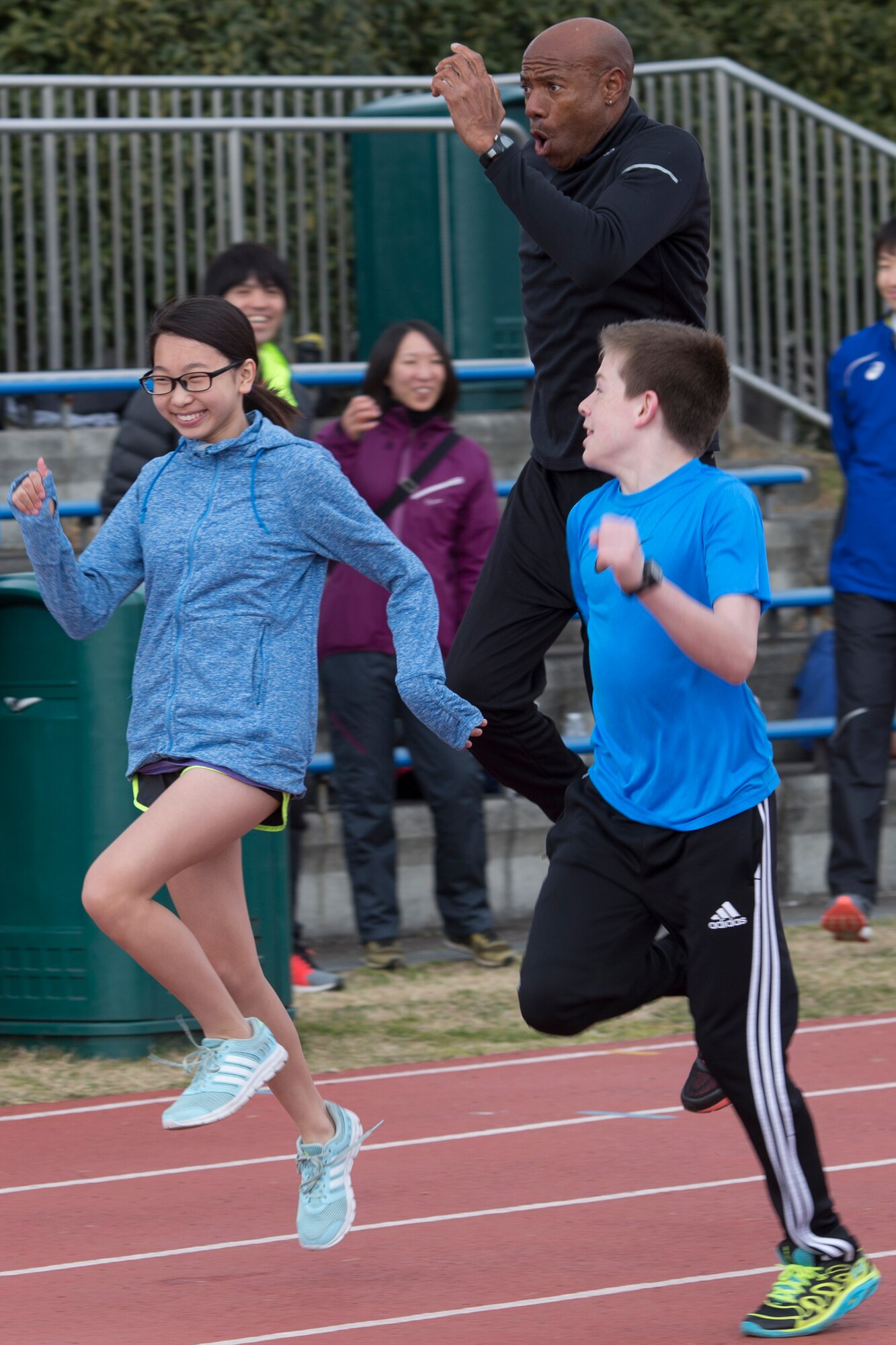Attendees from the Yokota Middle School ran with Mike Powell, the world record holder in the long jump, during the world records camp at Yokota Air Base, Japan, March 12, 2016. Yokota Striders Running Club hosted the camp for all school ages students. Over 70 junior high school and high school students participated in the two-day camp. (U.S. Air Force photo by Osakabe Yasuo/Released)
