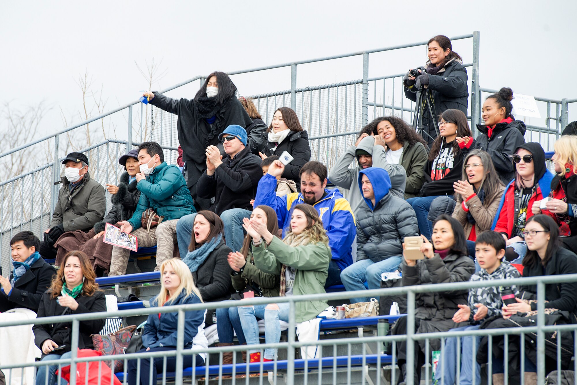 Family and friends from military installations across the Indo-Asia Pacific Region gather to cheer on the high school students of Team USA at Amino Vital Stadium, Tokyo, Japan, March 13, 2016. Formerly known as the Carnelia Bowl, the event's name was changed to Tomodachi Bowl in remembrance of the Tohoku Earthquake and Tsunami in 2011. (U.S. Air Force photo by Senior Airman David C. Danford/Released)