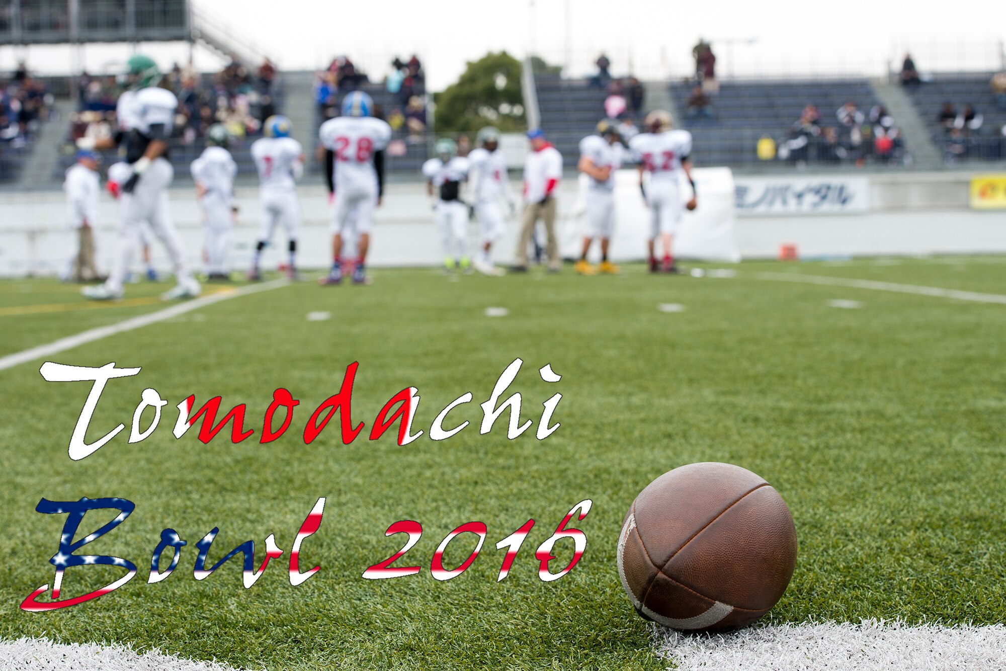 A football lies on the field as Team USA and Rising Sun prepare to compete in Tomodachi Bowl 2016 at Amino Vital Stadium, Tokyo, Japan, March 13, 2016. Tomodachi, Japanese for friend, is also the name used for the disaster relief operation following the Tohoku Earthquake and Tsunami in 2011. (U.S. Air Force graphic by Senior Airman David C. Danford/Released)