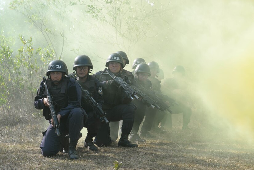 Honduran response forces pop smoke to visually communicate with a U.S. Army CH-47 Chinook helicopter to land, Feb. 26, 2016, during preparation for a personnel recovery exercise. The Hondurans conducted the training to prepare them for a personnel recovery exercise in which they would integrate with U.S. responding forces to provide security of a simulated downed. (U.S. Air Force photo by Staff Sgt. Westin Warburton/Released)