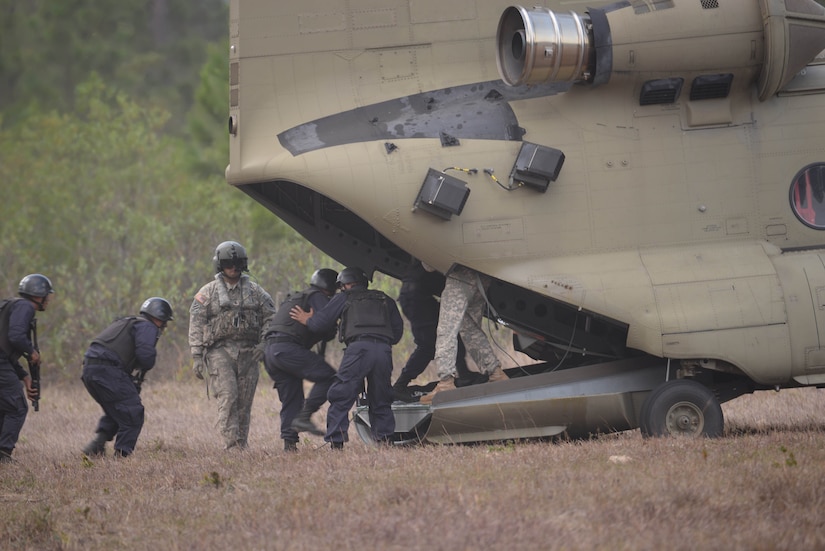 U.S. Army Sgt. Jesse Gomez, 1-228 Aviation Battalion crew chief, directs Honduran response forces as they board a U.S. Army CH-47 Chinook helicopter Feb. 26, 2016, near Soto Cano Air Base, Honduras, prior to a personnel recovery exercise. U.S and Honduran forces regularly train together to build their knowledge of techniques and capabilities in case they would ever need to operate together in real-world personnel recovery scenario. (U.S. Air Force photo by Staff Sgt. Westin Warburton/Released)