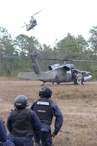 Honduran forces who provide security during personnel recovery situations receive helicopter load training on U.S. Army UH-60 Black Hawks and CH-47 Chinooks Feb. 26, 2016, near Soto Cano Air Base, Honduras. U.S and Honduran forces regularly train together to build their knowledge of techniques and capabilities in case they would ever need to operate together in real-world personnel recovery scenario. (U.S. Air Force photo by Staff Sgt. Westin Warburton/Released