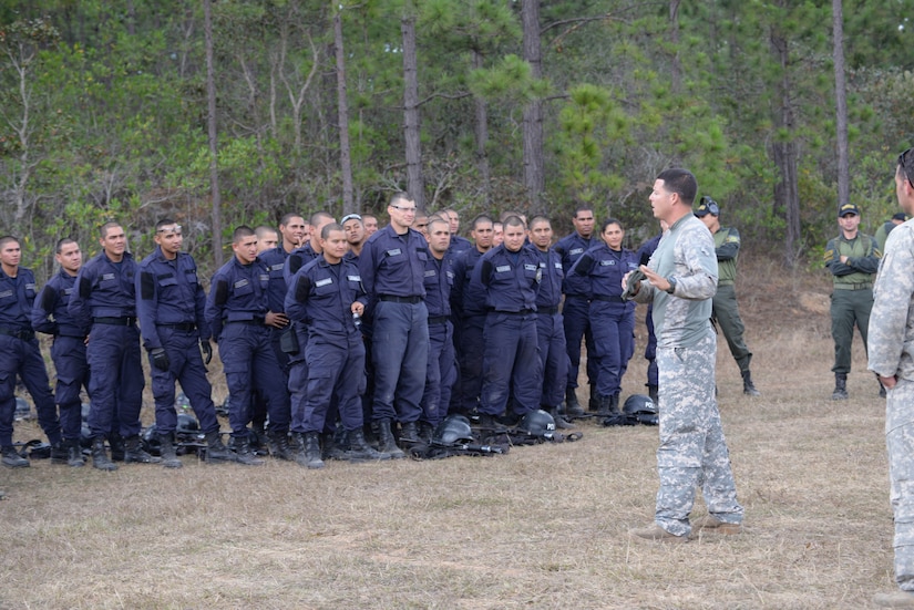 U.S. Army Sgt. Ruben Ramos, 1-228 Aviation Battalion crew chief, explains how to properly enter a U.S. Army UH-60 Blackhawk helicopter to Honduran forces and their trainers Feb. 26, 2016, near Soto Cano Air Base, Honduras. The Hondurans conducted the training to prepare them for a personnel recovery exercise in which they would integrate with U.S. responding forces to provide security of a simulated downed. (U.S. Air Force photo by Staff Sgt. Westin Warburton/Released)