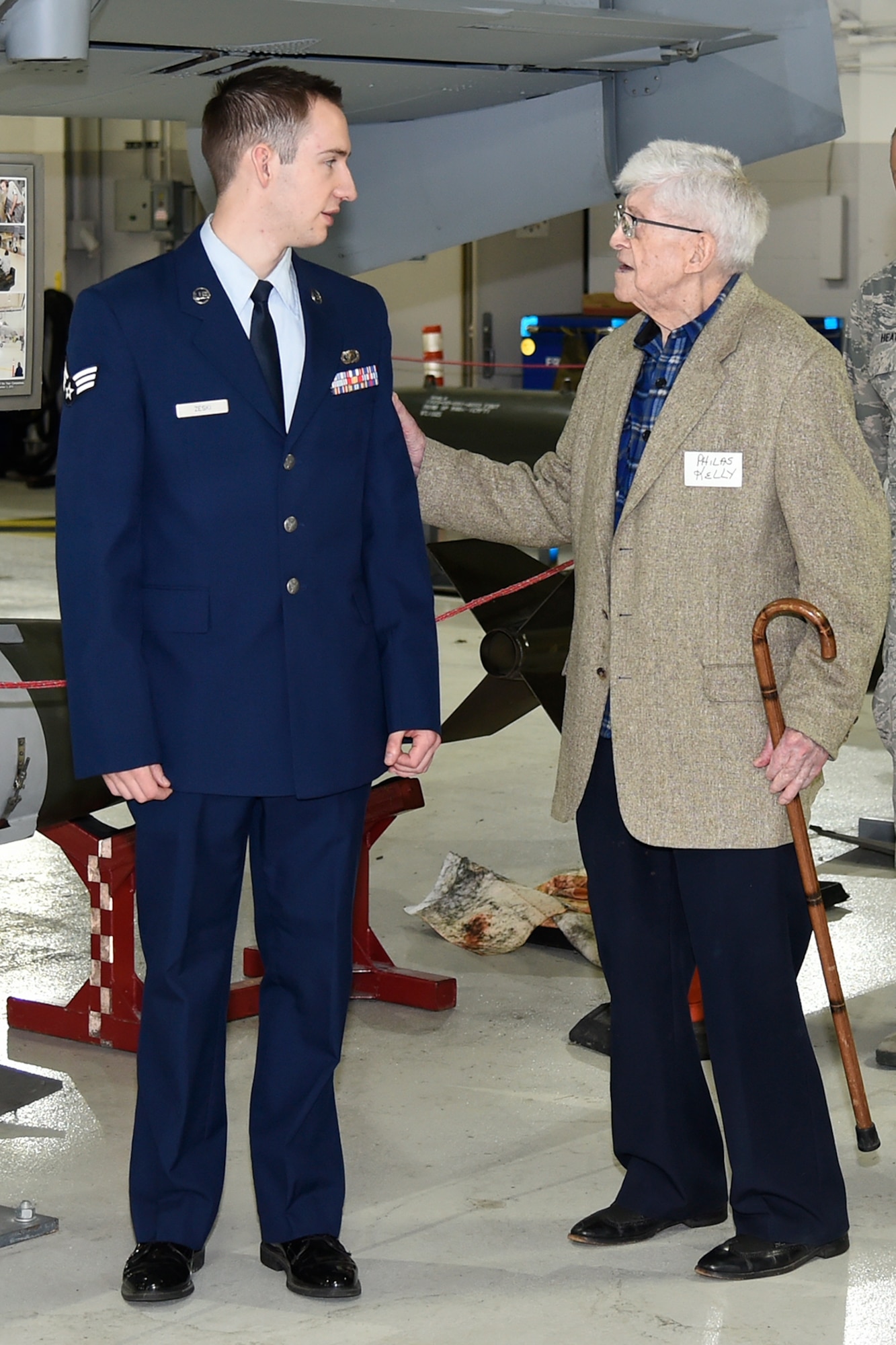 Philas Kelly, at age 102 likely the oldest living former photographer to have served in the National Guard, talks with Senior Airman Ryan Zeski, the youngest photojournalist currently serving in the Michigan Air National Guard’s 127th Wing at Selfridge Air National Guard Base. Kelly was recently a guest at the base to visit his old unit, now the 107th Fighter Squadron. (U.S. Air National Guard photo by Terry Atwell)