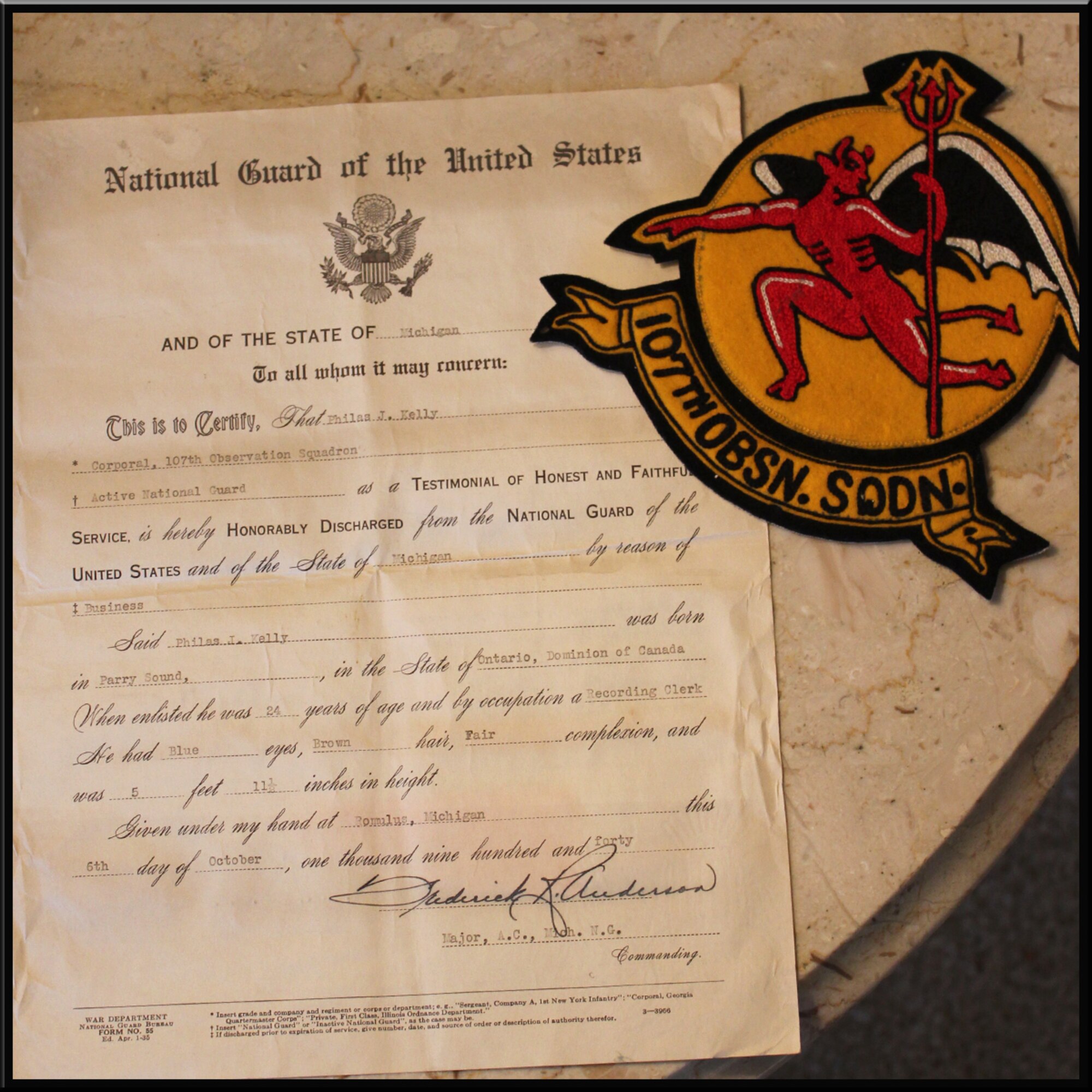 The discharge certificate and former squadron patch of Philas Kelly is seen in this Feb. 2, 2016 photo. Kelly, age 102, served in the 107th Observation Squadron, which is now the 107th Fighter Squadron, in the Michigan Air National Guard prior to World War II. (U.S. Air National Guard photo by Staff Sgt. Samara Taylor)