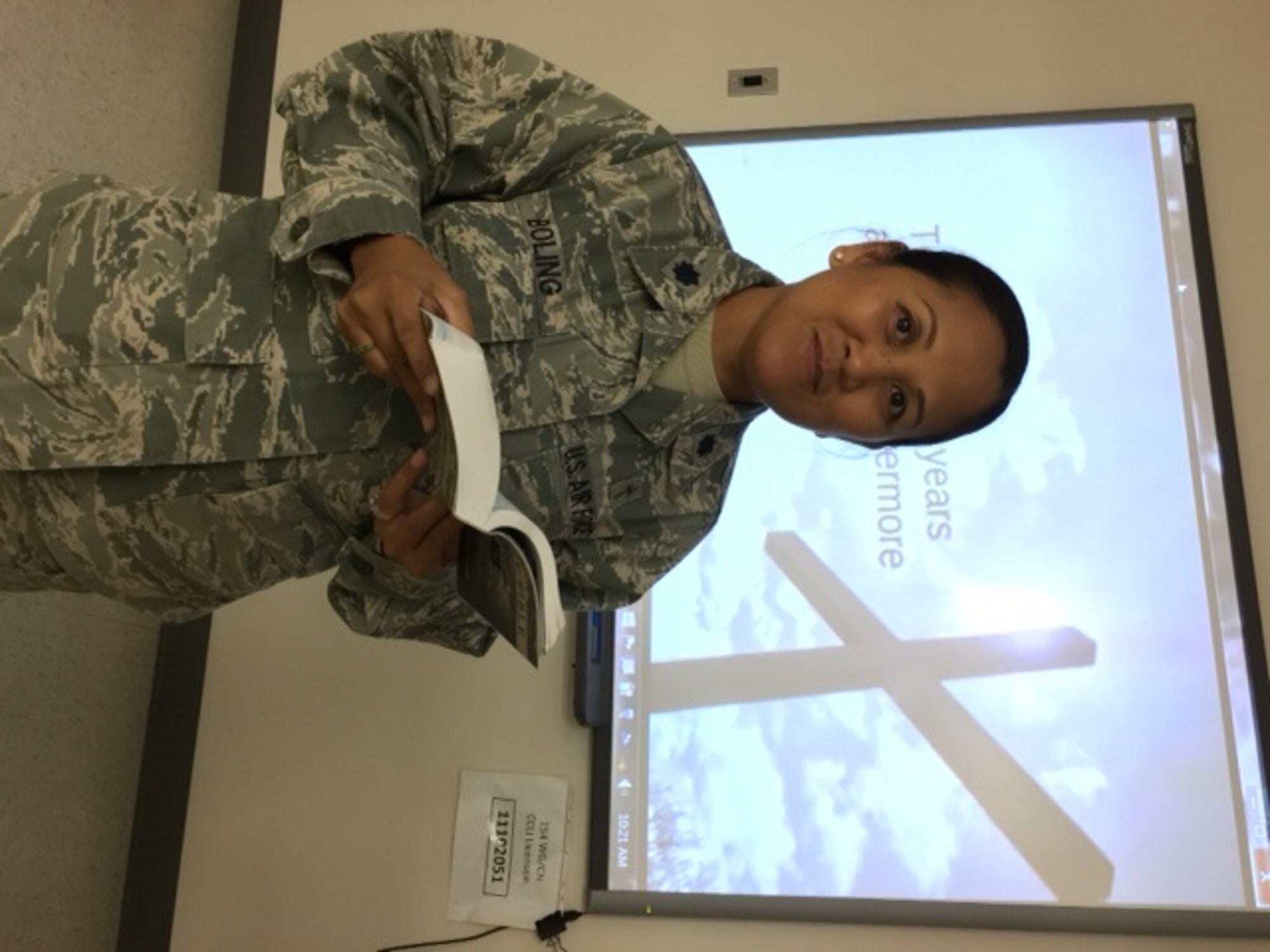 U.S. Air Force Lt. Col. Leah Boling, 154th Wing Chaplain, prepares to read scripture to Airmen during a religious service. Chaplain Boling is the 154th Wing's first and only female chaplain. (courtesy photo)