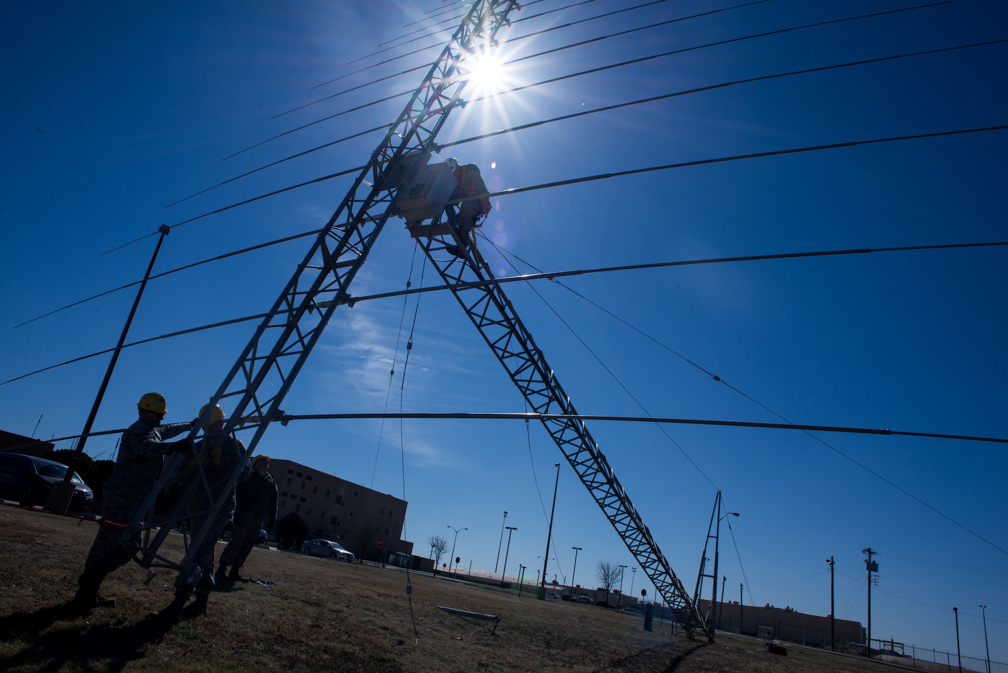 An Airman with the 205th Engineering Installation Squadron from Will Rogers Air National Guard Base in Oklahoma City, climbs an antenna tower to make repairs while his fellow 205 EIS Airmen help keep the lightweight rotatable antenna steady, March 5, 2016, at Tinker Air Force Base in Oklahoma City. These Airmen were a part of one of the two teams from the 205 EIS guard unit that worked to setup and repair antennas for active-duty squadrons at Tinker AFB.