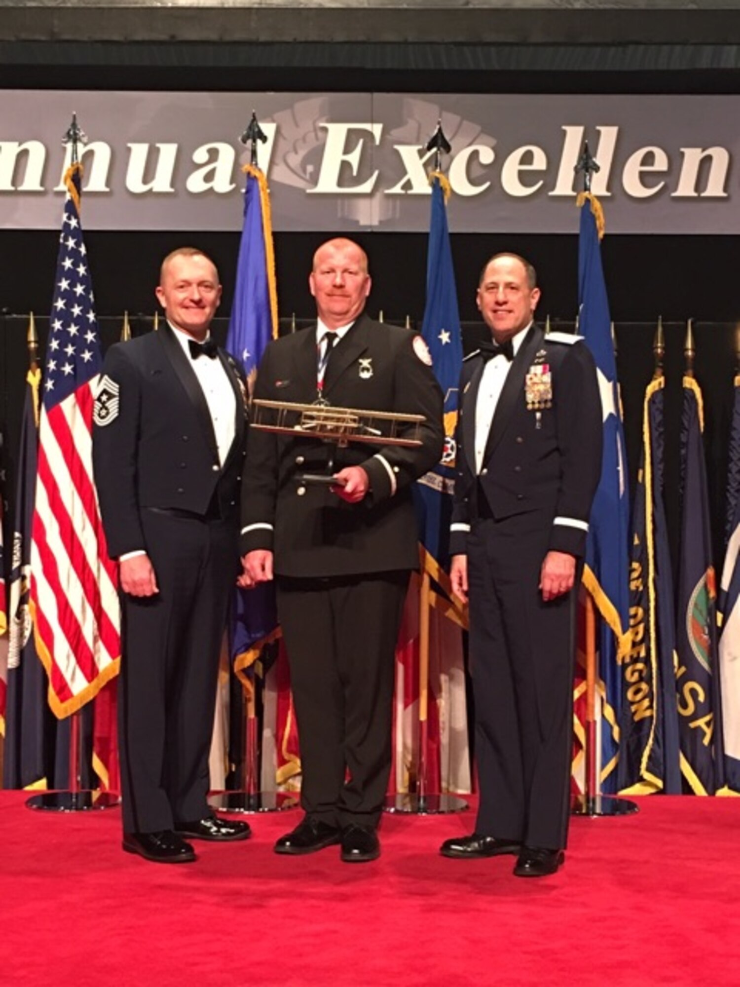 Mr. Steven Smith (center) from Robins Air Force Base is the Air Force Materiel Command's 2015 Annual Excellence Award winner of the Civilian Category I. Here he stands with Chief Master Sgt. Jason L. France (left), AFSC Command Chief and Lt. Gen. Lee K Levy II, AFSC Commander, after the awards ceremony March 9, 2016, on Wright-Patterson AFB.