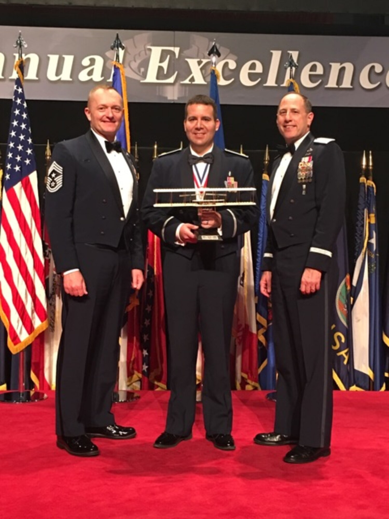 Maj. David Jarnot (center) from Hill Air Force Base is the Air Force Materiel Command's 2015 Annual Excellence Award winner of the Field Grade Officer category. Here he stands with Chief Master Sgt. Jason L. France (left), AFSC Command Chief and Lt. Gen. Lee K Levy II, AFSC Commander, after the awards ceremony March 9, 2016, on Wright-Patterson AFB.