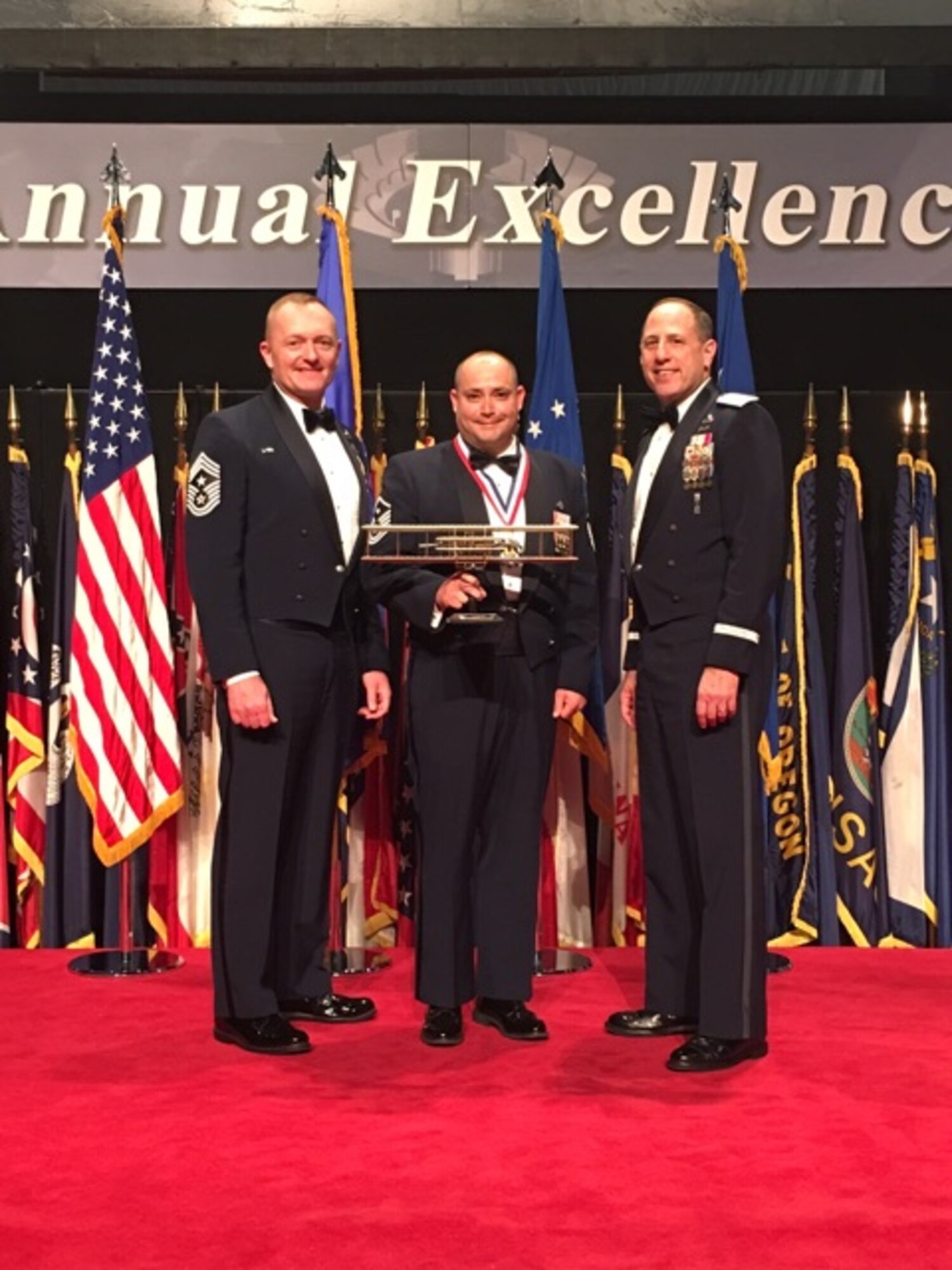 Master Sgt. Brian Partido (center) from Tinker Air Force Base is the Air Force Materiel Command's 2015 Annual Excellence Award winner of the First Sergeant category. Here he stands with Chief Master Sgt. Jason L. France (left), AFSC Command Chief and Lt. Gen. Lee K Levy II, AFSC Commander, after the awards ceremony March 9, 2016, on Wright-Patterson AFB.